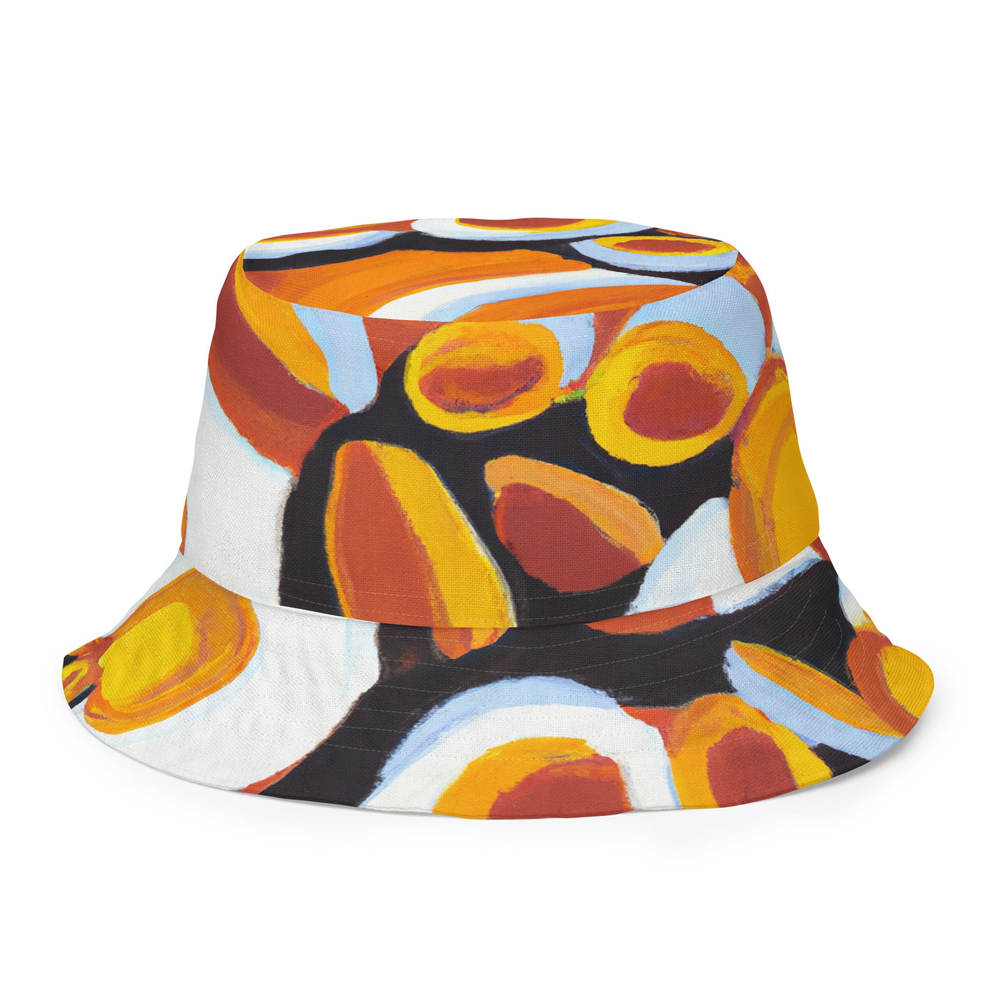 Reversible bucket hat featuring an orange, black, and white geometric print pattern, showcasing its stylish design and premium fabric.