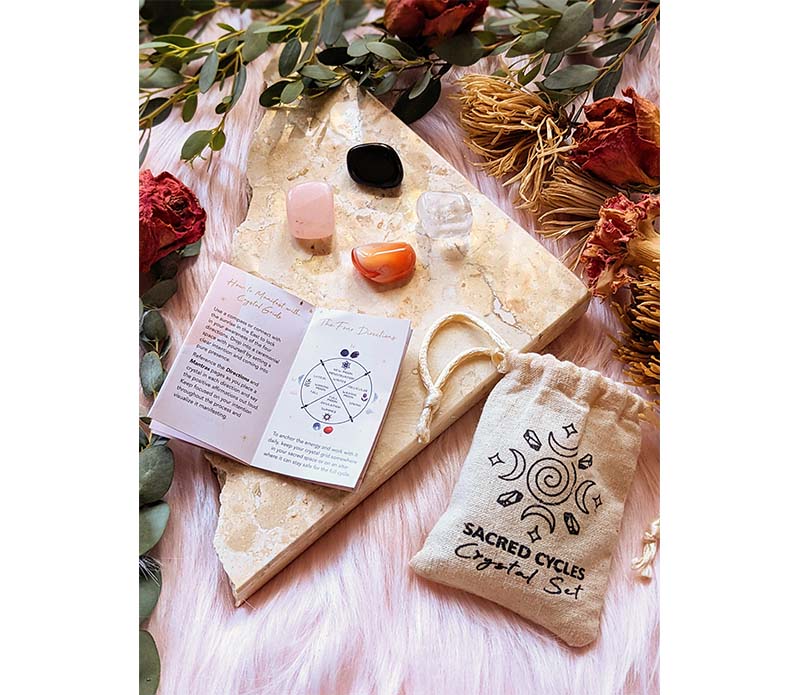 Sacred Cycles Crystal Set featuring obsidian, clear quartz, carnelian, and rose quartz in a muslin bag, ideal for spiritual rituals.