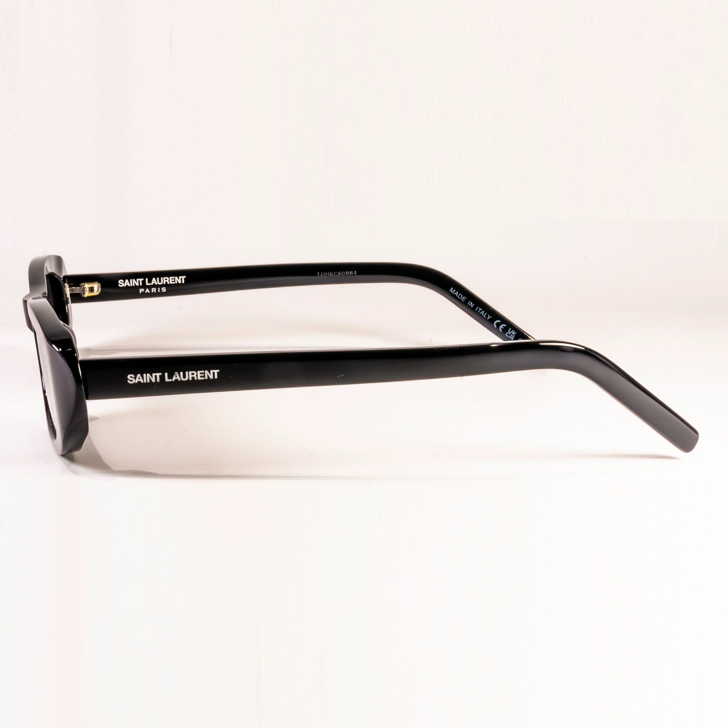 Saint Laurent Sunglasses SL 557 featuring a sleek black plastic frame and nylon lenses in a stylish round-oval shape.