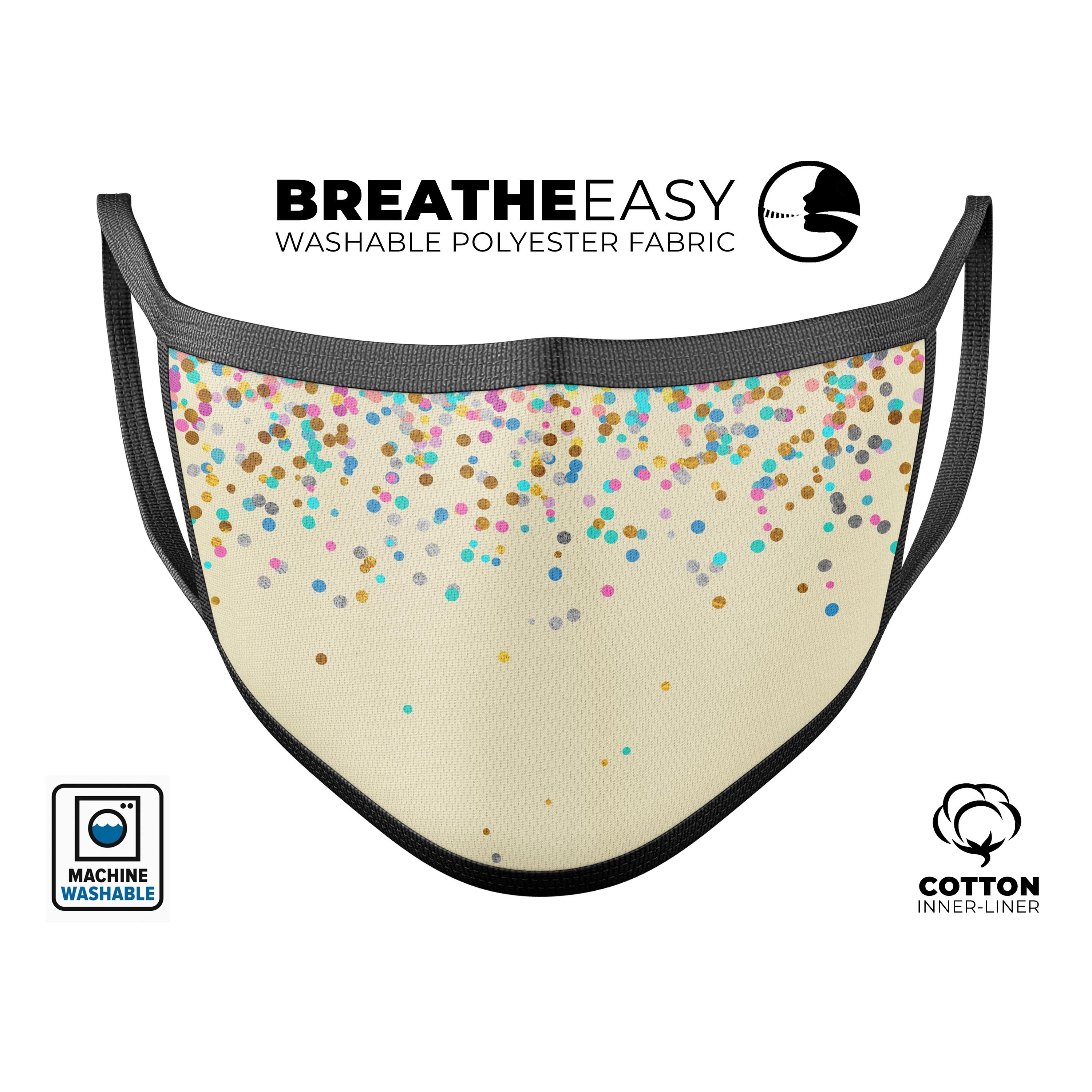 Colorful birthday-themed mouth cover with scattered dots on a tan background, made in the USA.