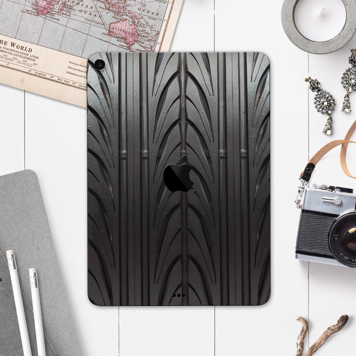 Shiny Black Tire Tread Full Body Skin Decal for Apple iPad Pro, showcasing a sleek design and premium finish.