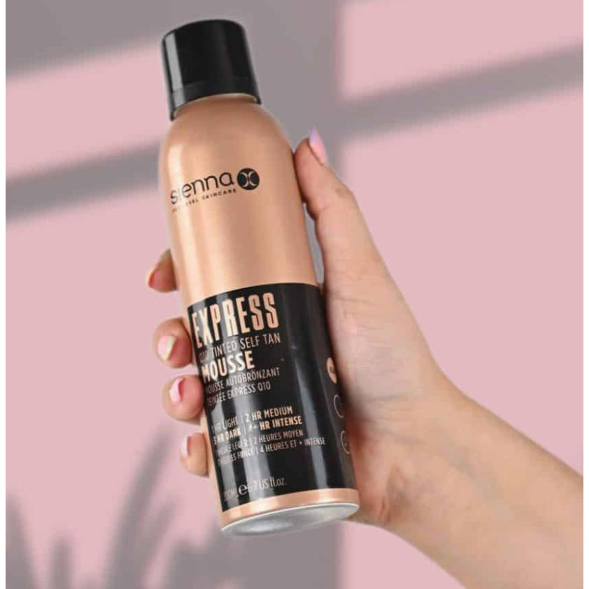 Sienna X EXPRESS Q10 Self Tan Tinted Mousse bottle with a foamy texture, showcasing its light and airy consistency for easy application.