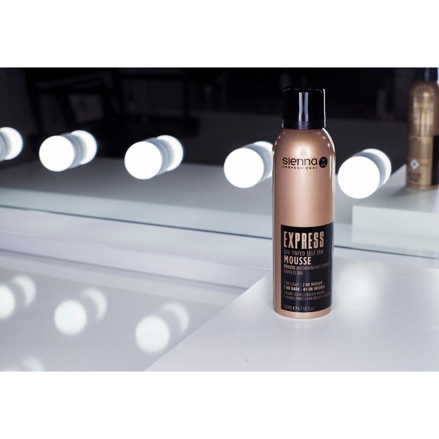 Sienna X EXPRESS Q10 Self Tan Tinted Mousse bottle with a foamy texture, showcasing its light and airy consistency for easy application.