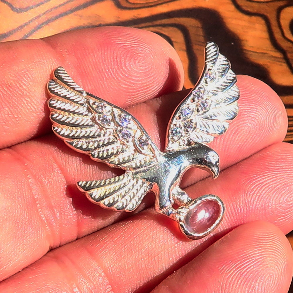 Sterling Silver Eagle Pendant featuring a Ceylon Moonstone and sparkling Cubic Zirconias, showcasing intricate eagle wing design.