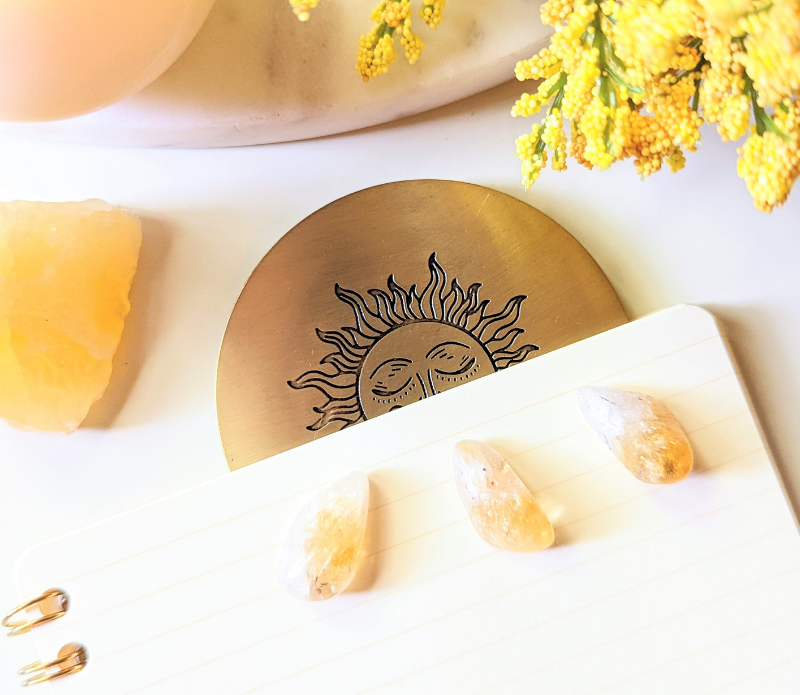 Solar Radiance Bookmark made of unpolished brass, featuring a circular design, perfect for marking pages in books or planners.