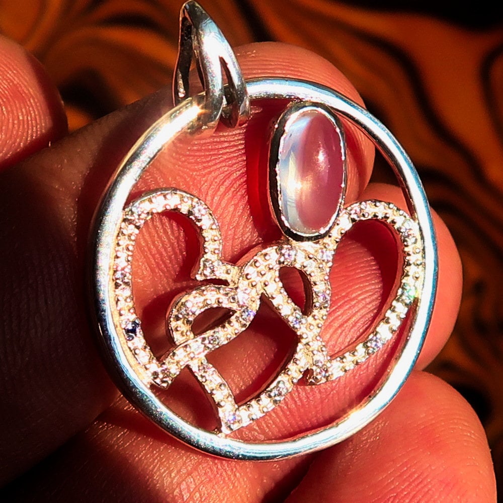 Sterling Silver Pendant with three hearts and Ceylon Moonstone, featuring Cubic Zirconia accents, elegantly designed for a romantic gift.