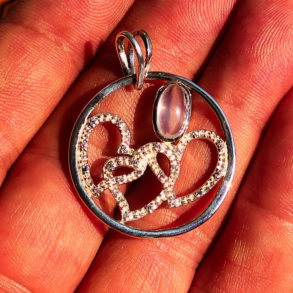 Sterling Silver Pendant with three hearts and Ceylon Moonstone, featuring Cubic Zirconia accents, elegantly designed for a romantic gift.