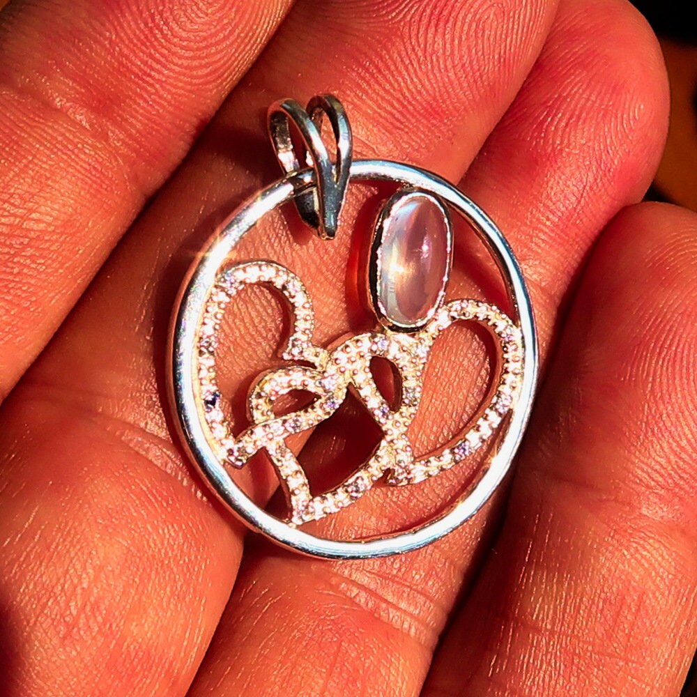 Sterling Silver Pendant with three hearts and Ceylon Moonstone, featuring Cubic Zirconia accents, elegantly designed for a romantic gift.