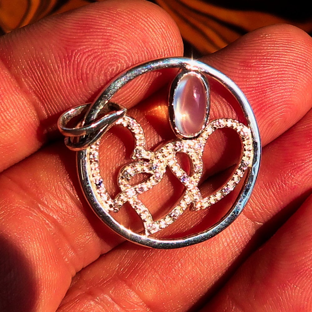 Sterling Silver Pendant with three hearts and Ceylon Moonstone, featuring Cubic Zirconia accents, elegantly designed for a romantic gift.