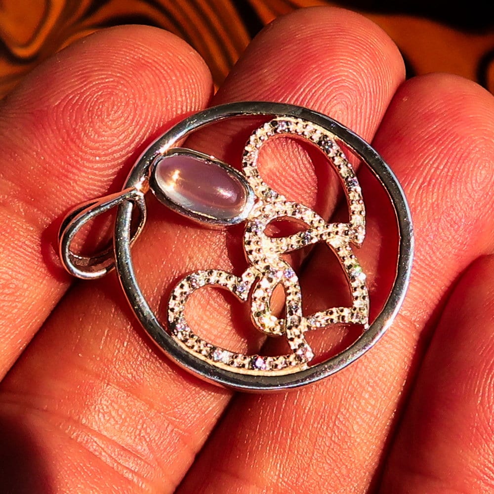 Sterling Silver Pendant with three hearts and Ceylon Moonstone, featuring Cubic Zirconia accents, elegantly designed for a romantic gift.