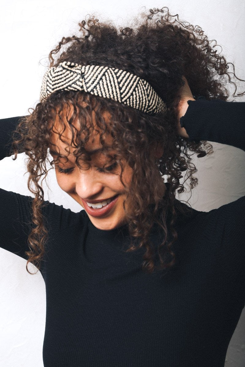 A stylish straw rattan knotted headband, perfect for elevating any hairstyle with a chic touch.