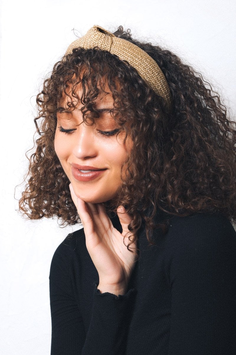 A stylish straw rattan knotted headband, perfect for elevating any hairstyle with a chic touch.