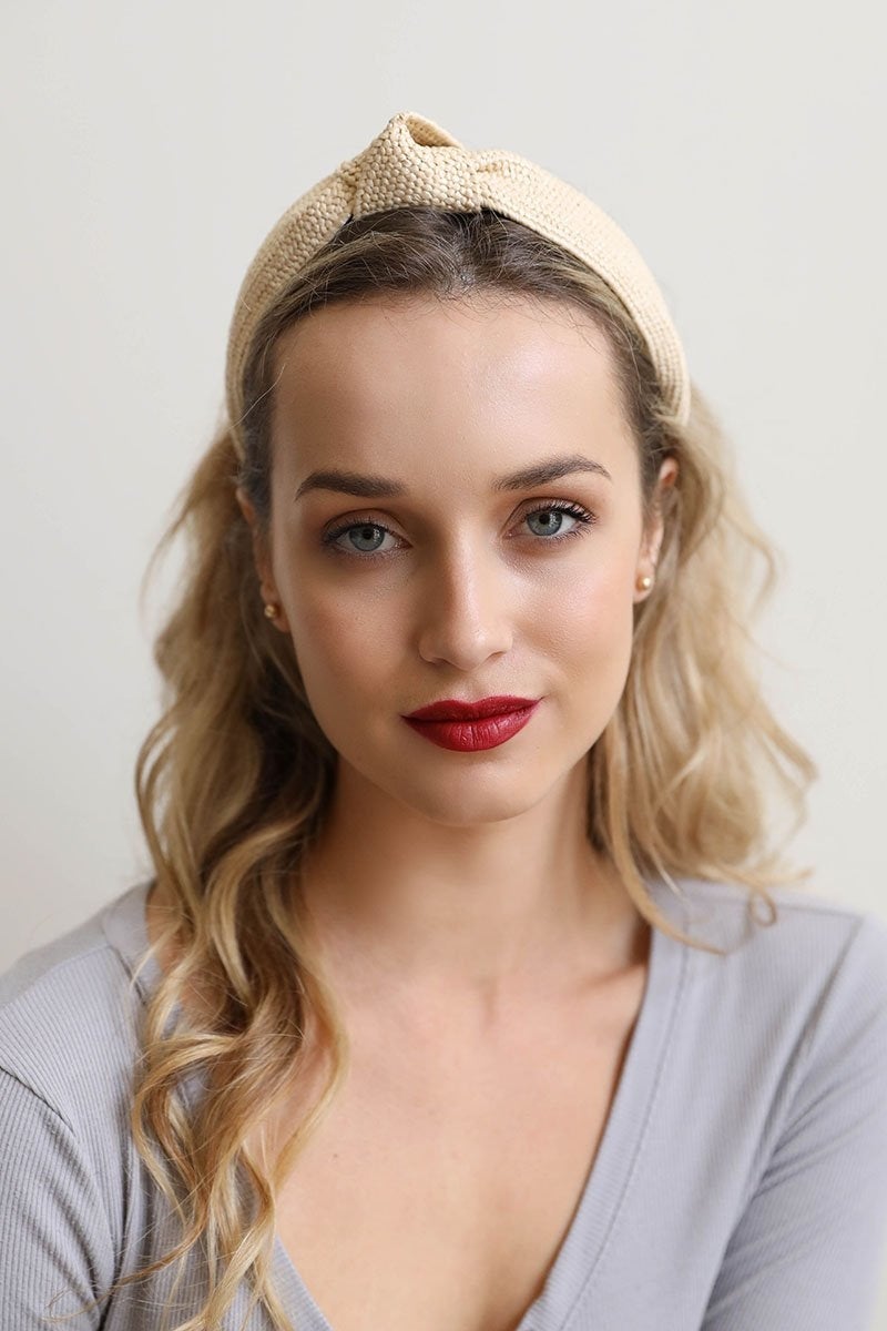 A stylish straw rattan knotted headband, perfect for elevating any hairstyle with a chic touch.