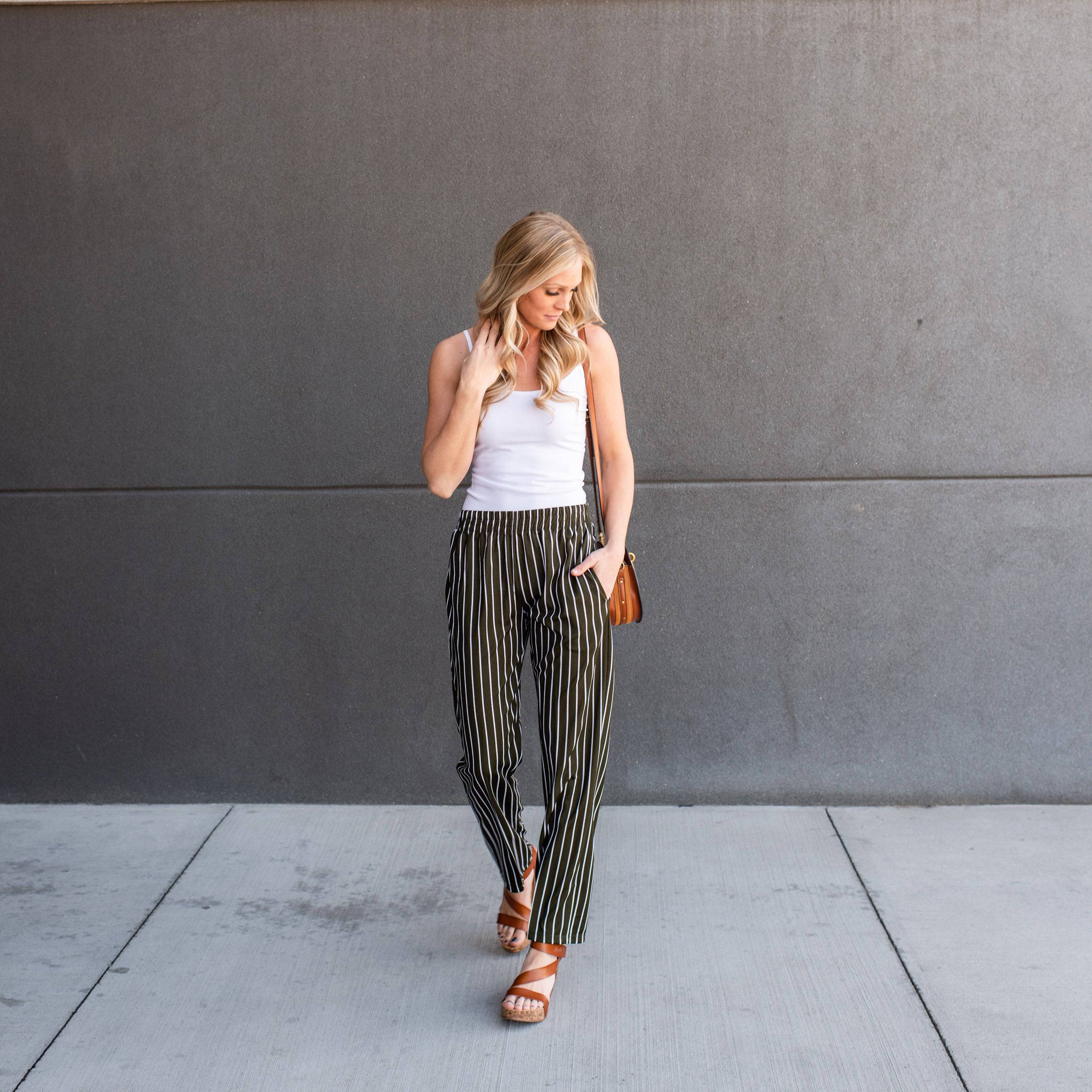 A pair of stylish striped dress pants, showcasing a relaxed fit and lightweight material, perfect for professional and casual settings.