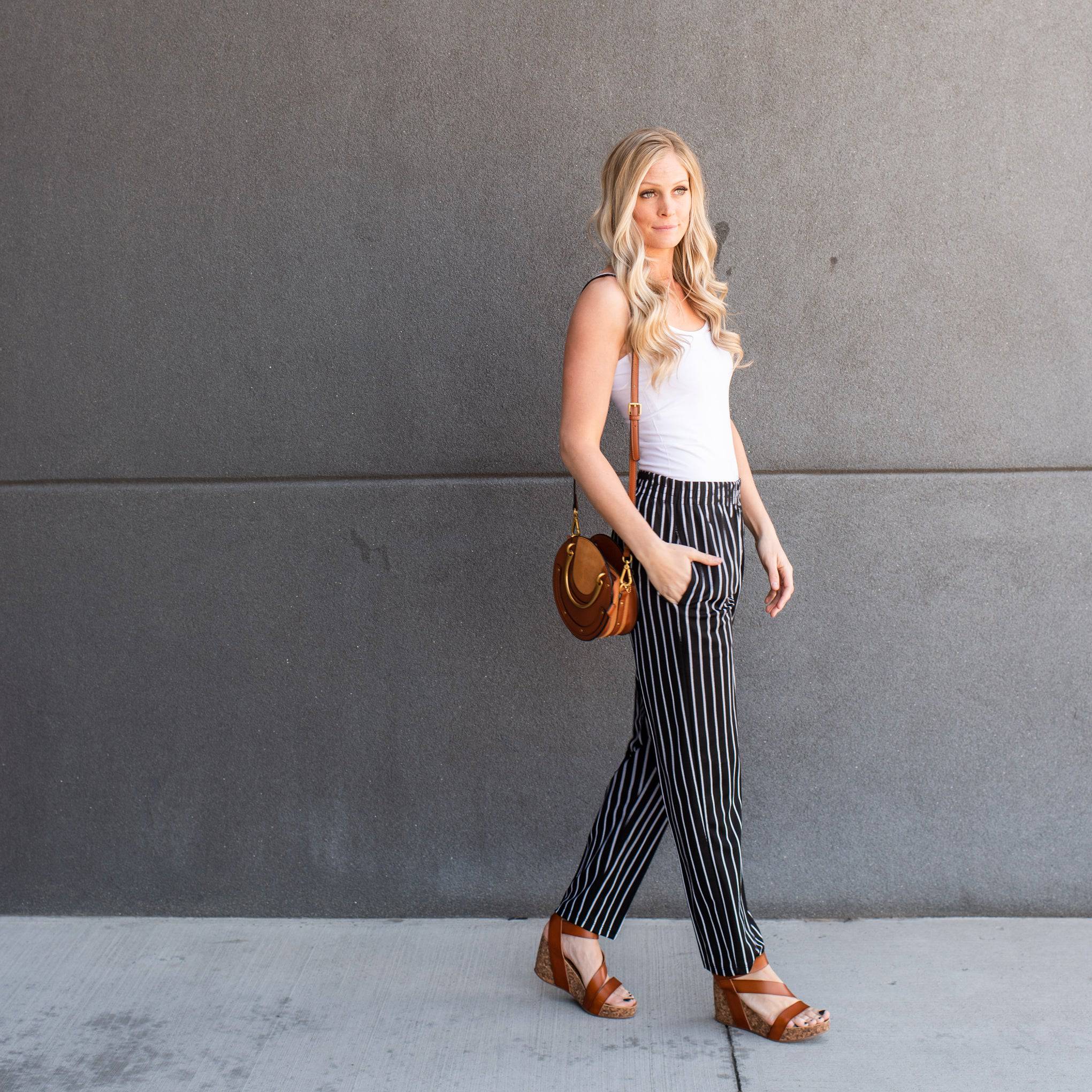 A pair of stylish striped dress pants, showcasing a relaxed fit and lightweight material, perfect for professional and casual settings.