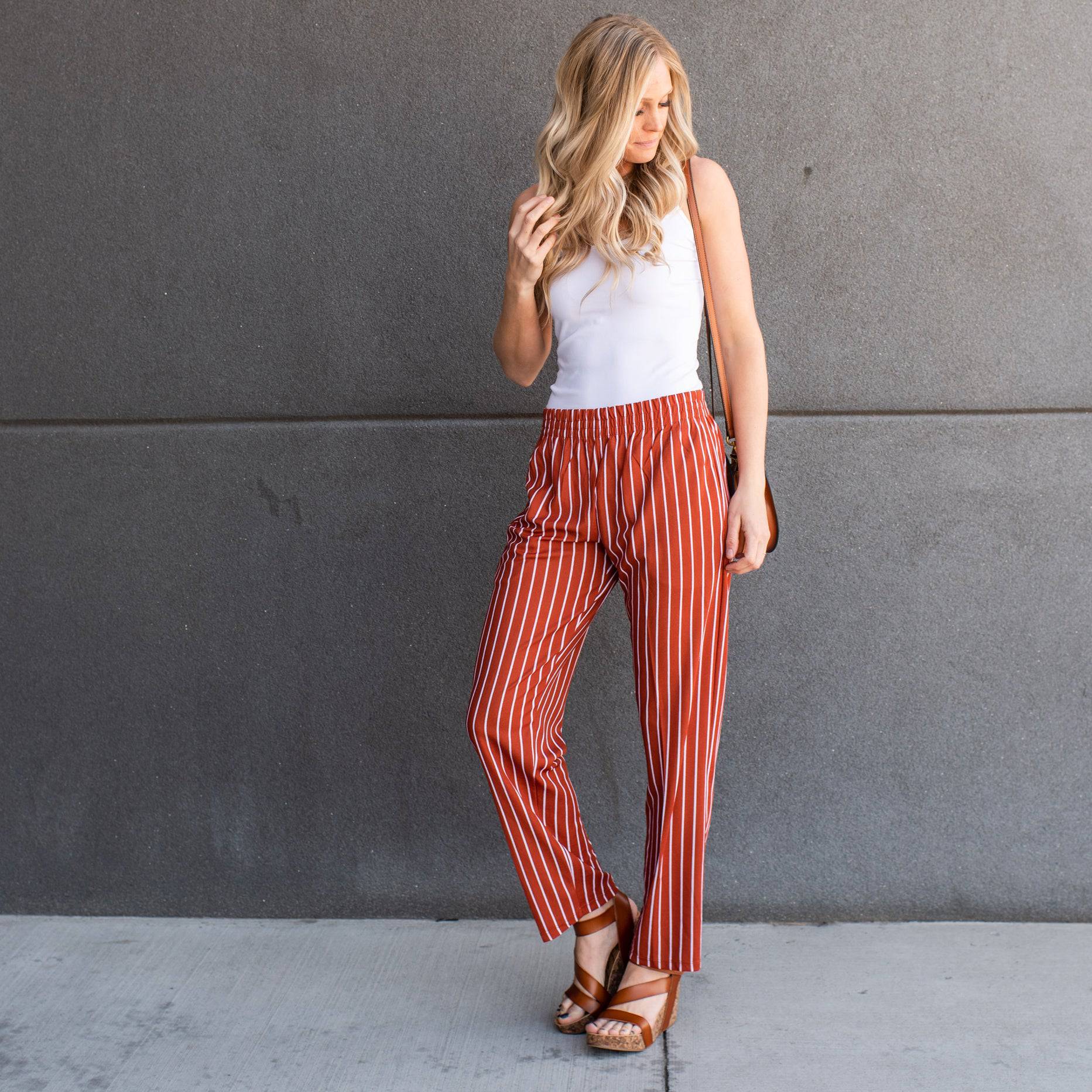 A pair of stylish striped dress pants, showcasing a relaxed fit and lightweight material, perfect for professional and casual settings.