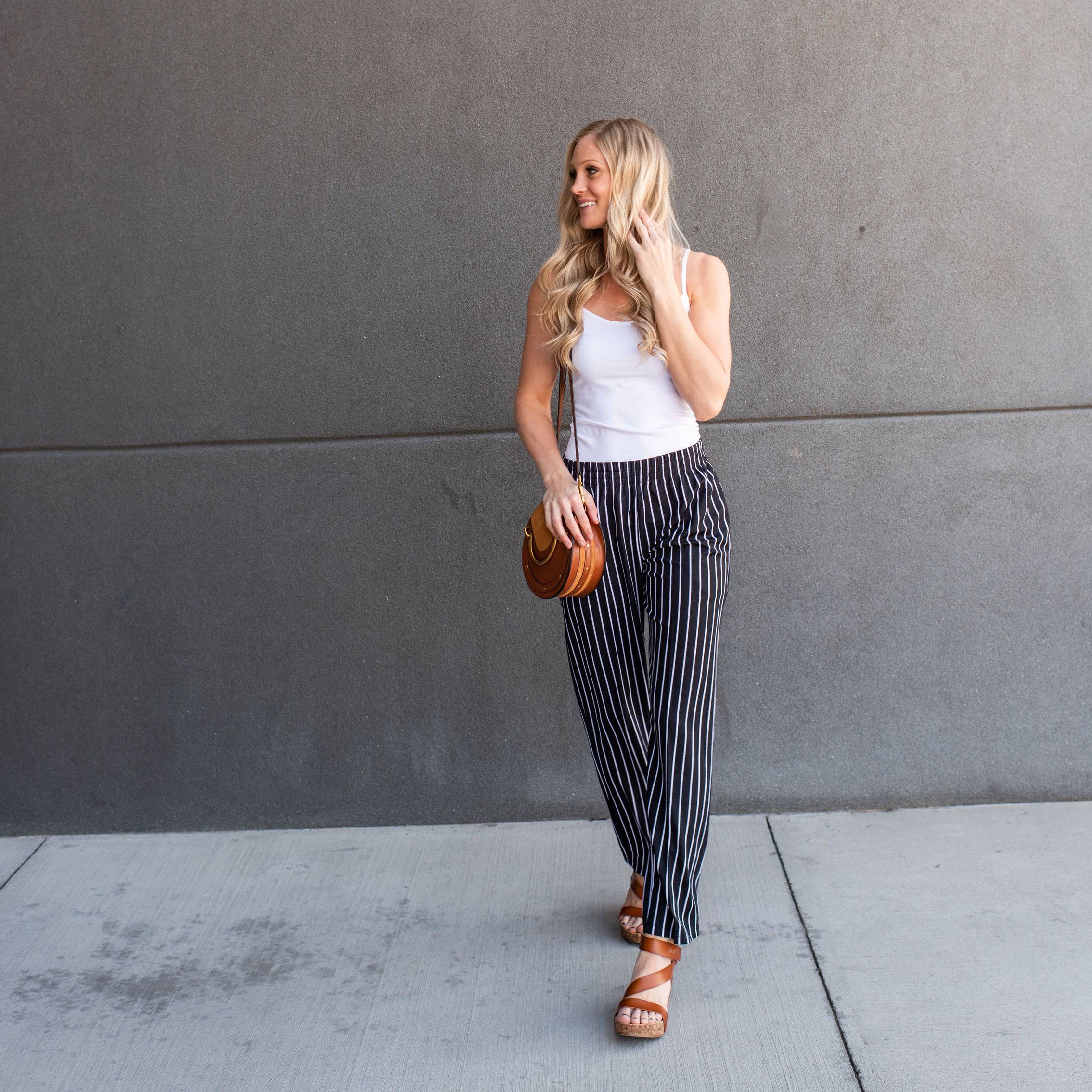 A pair of stylish striped dress pants, showcasing a relaxed fit and lightweight material, perfect for professional and casual settings.