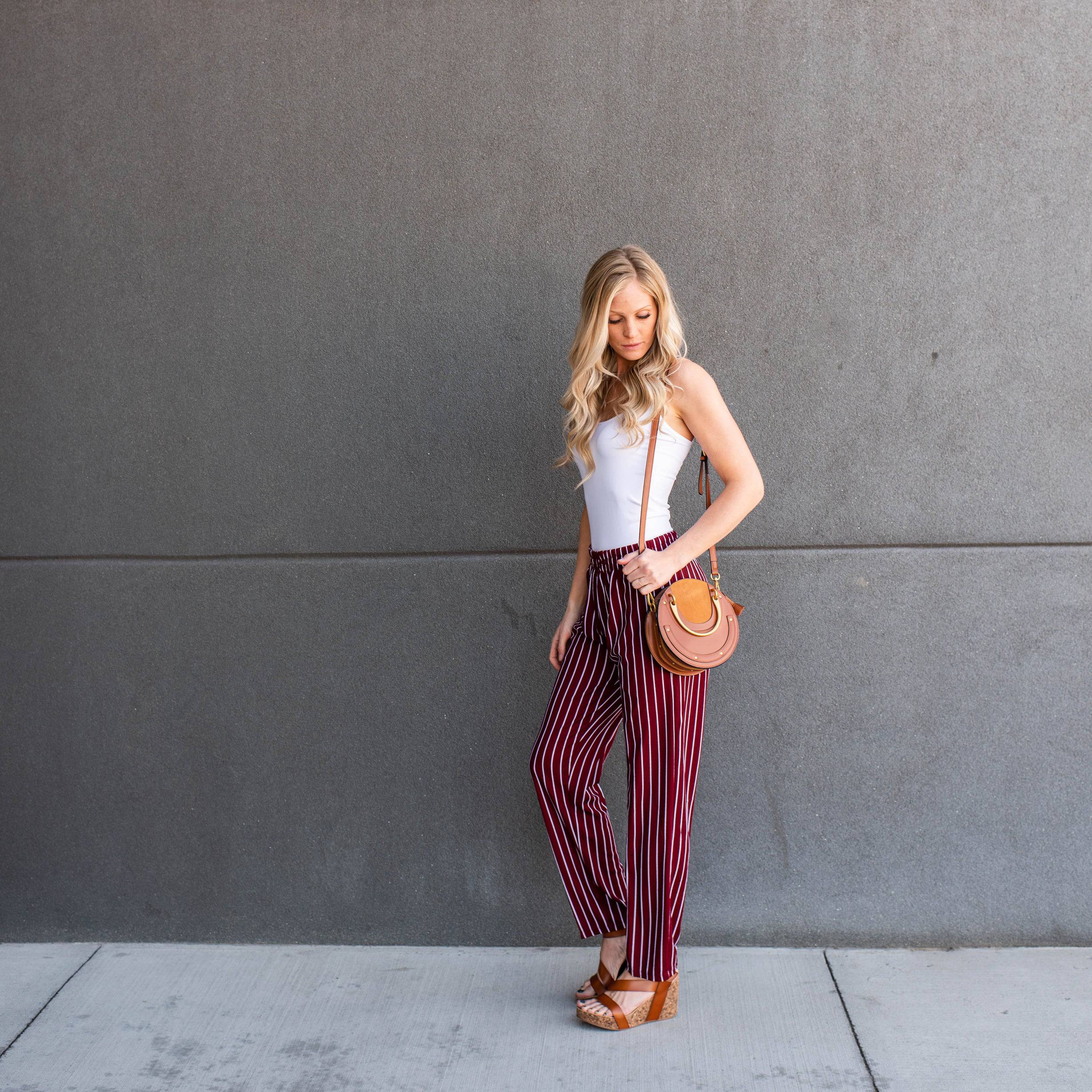 A pair of stylish striped dress pants, showcasing a relaxed fit and lightweight material, perfect for professional and casual settings.