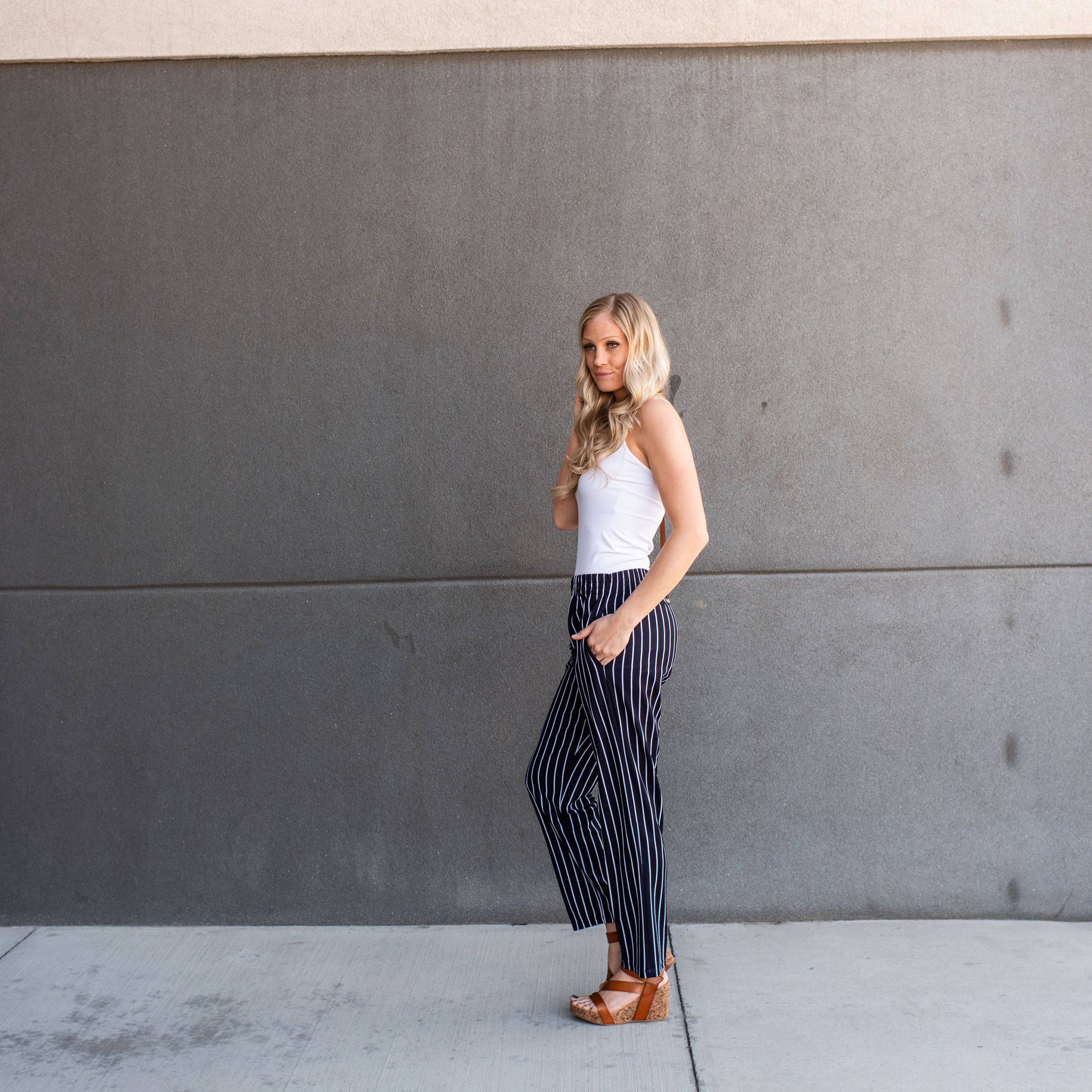 A pair of stylish striped dress pants, showcasing a relaxed fit and lightweight material, perfect for professional and casual settings.