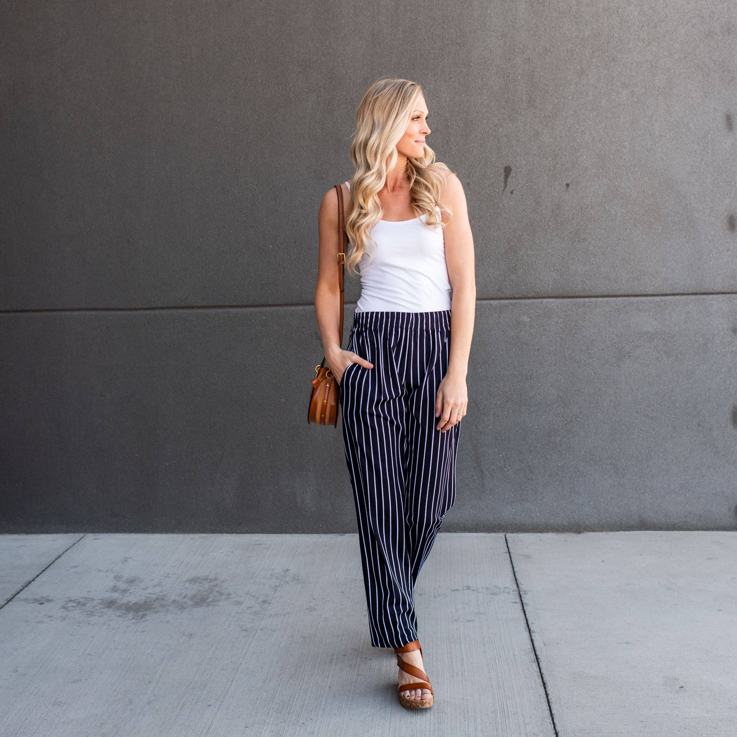 A pair of stylish striped dress pants, showcasing a relaxed fit and lightweight material, perfect for professional and casual settings.