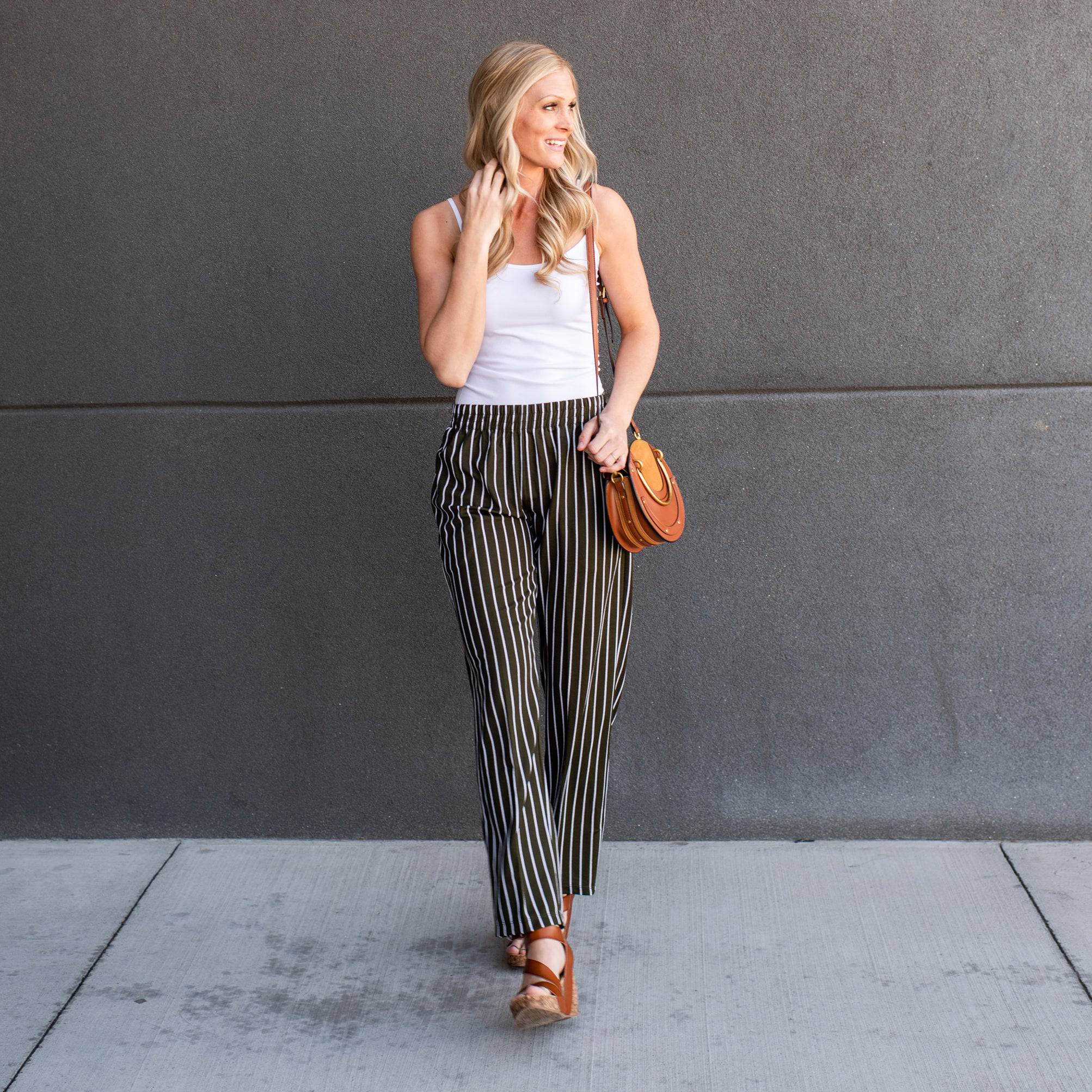 A pair of stylish striped dress pants, showcasing a relaxed fit and lightweight material, perfect for professional and casual settings.