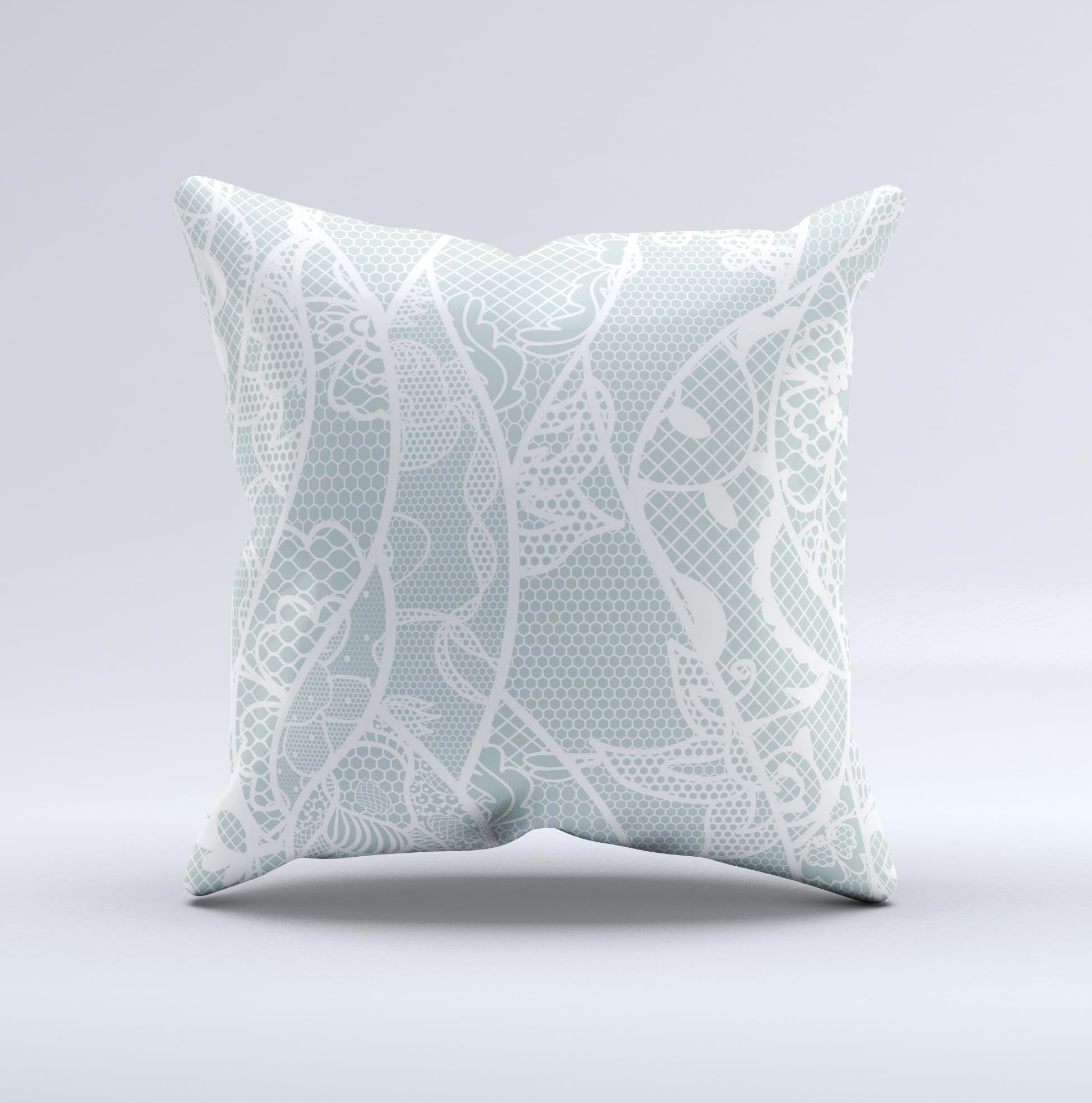 Subtle green and white decorative throw pillow with lace design, handcrafted in Virginia, showcasing unique imperfections.