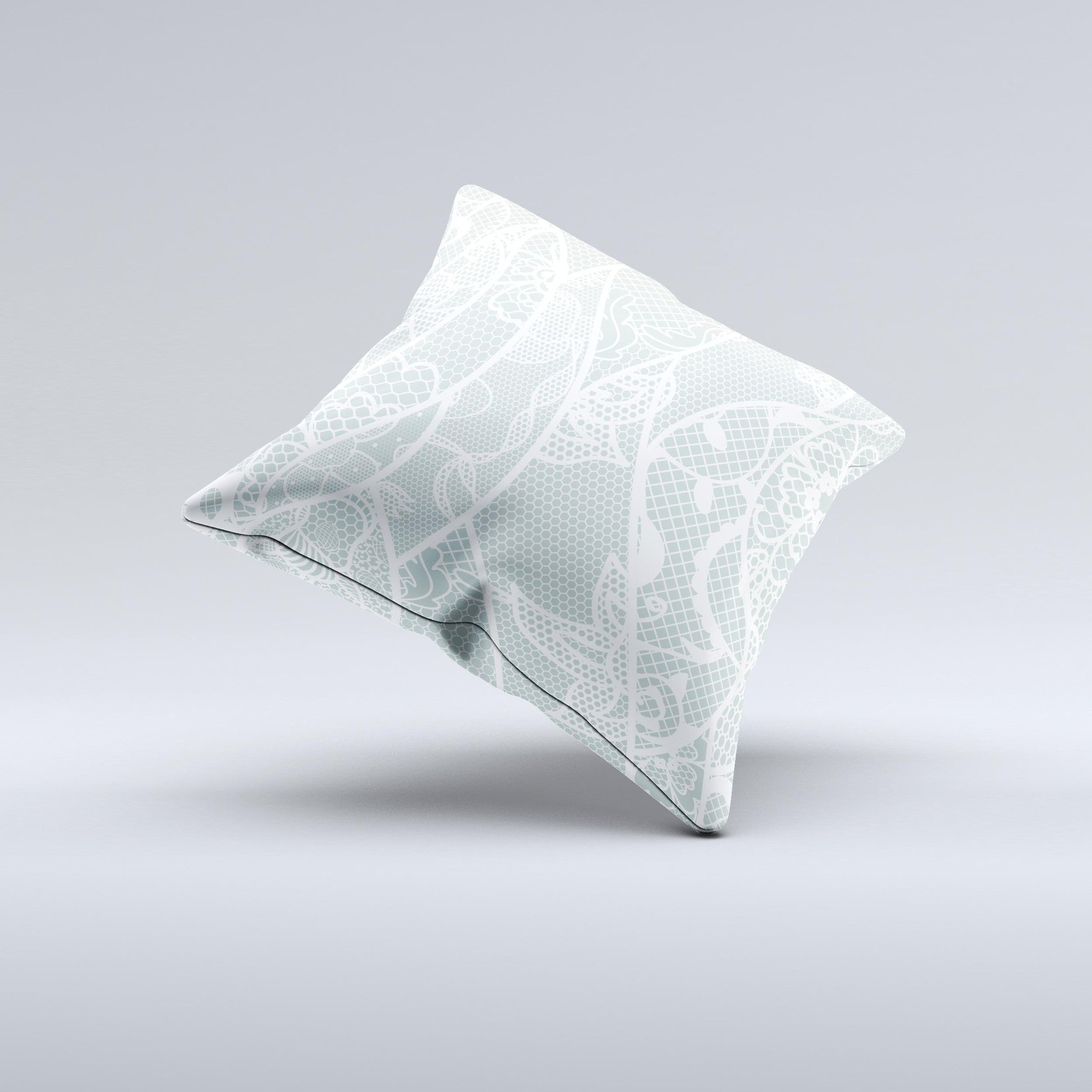 Subtle green and white decorative throw pillow with lace design, handcrafted in Virginia, showcasing unique imperfections.