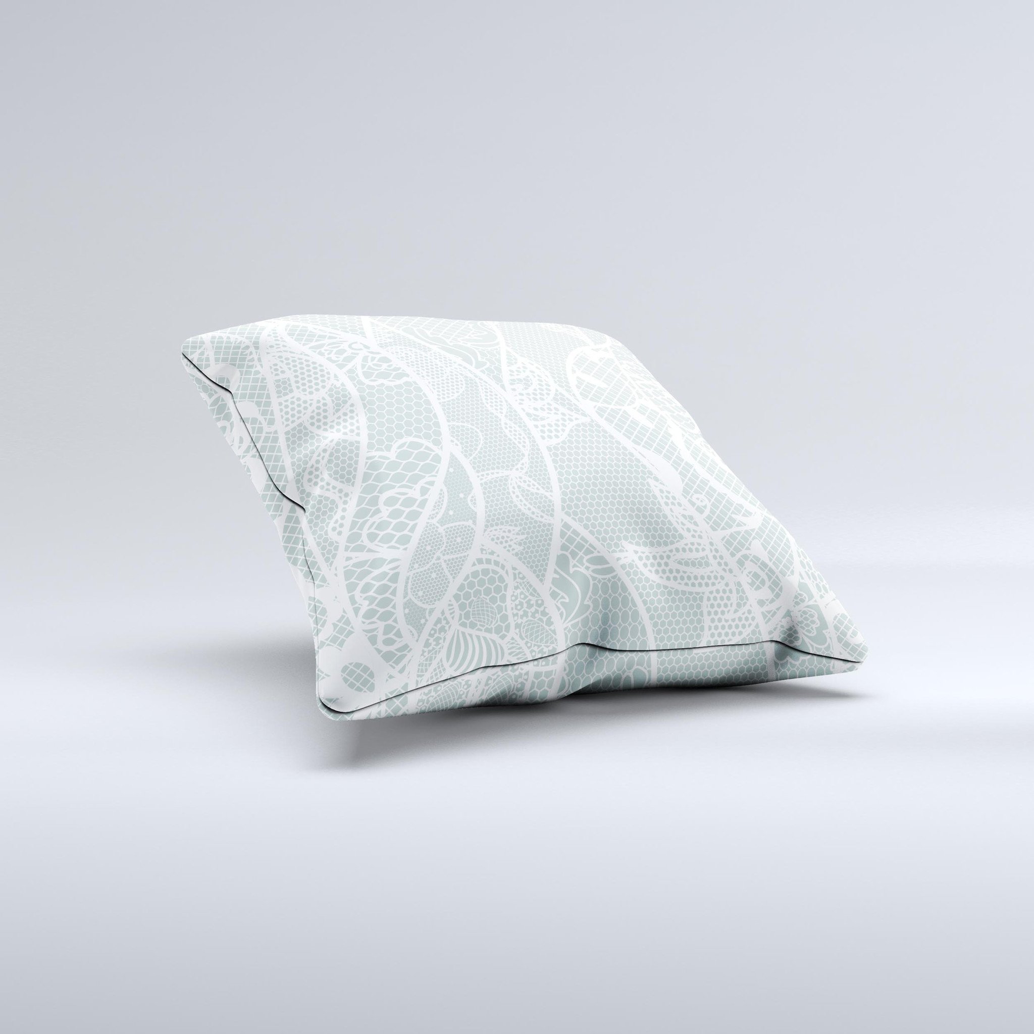 Subtle green and white decorative throw pillow with lace design, handcrafted in Virginia, showcasing unique imperfections.