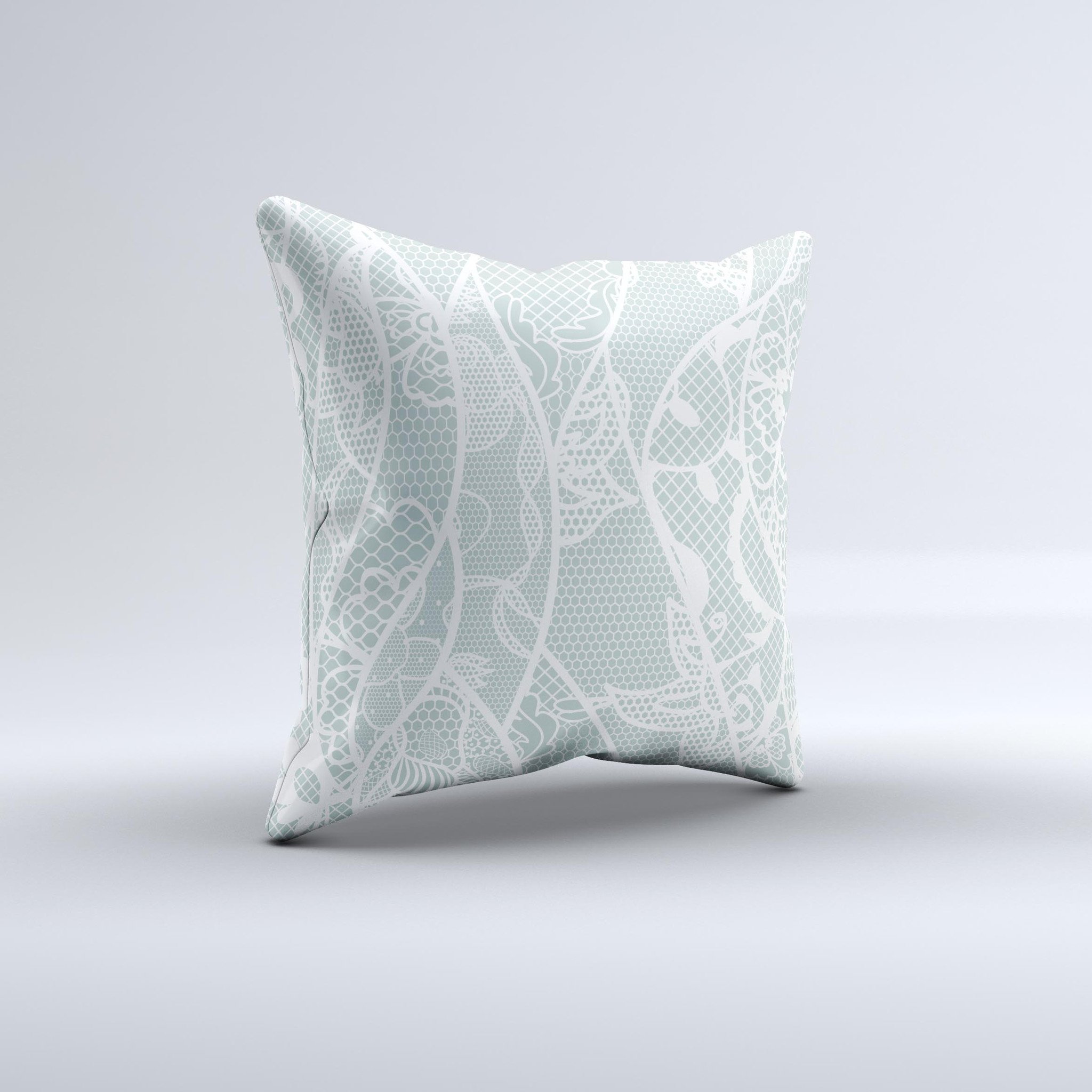 Subtle green and white decorative throw pillow with lace design, handcrafted in Virginia, showcasing unique imperfections.