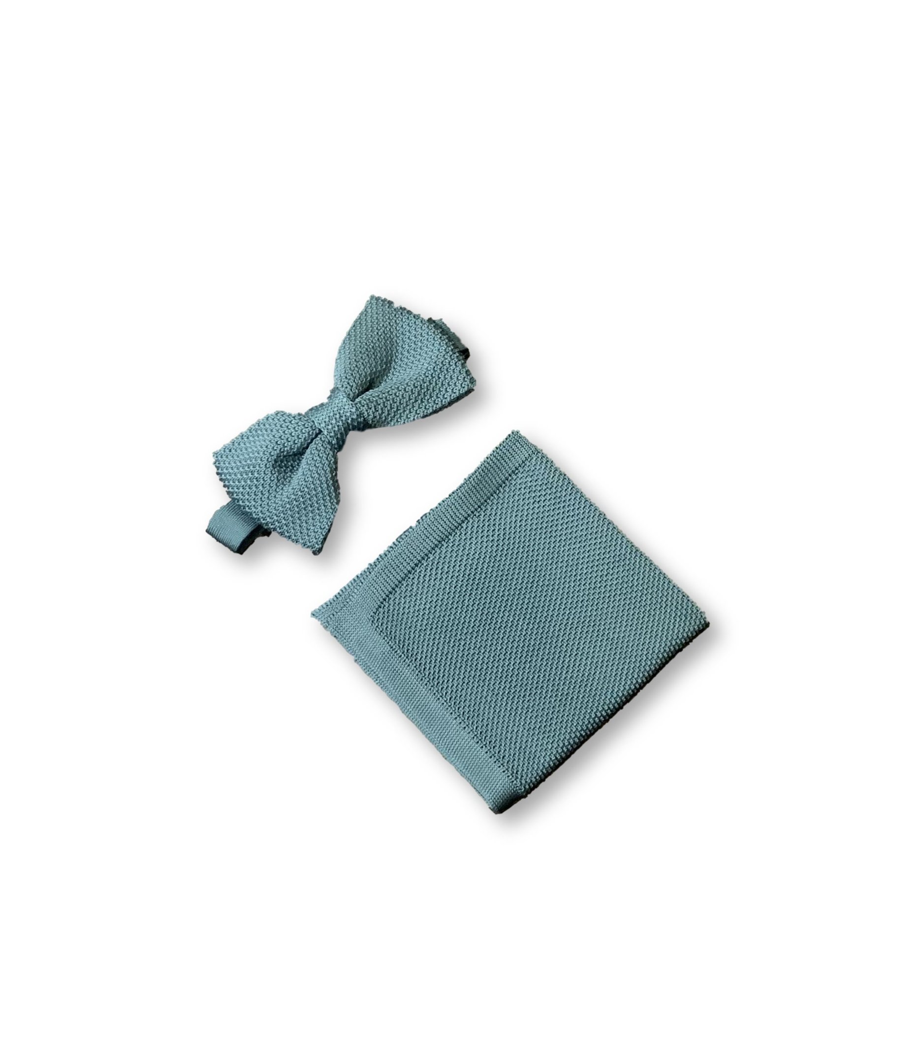 Teal knitted bow tie and matching pocket square set displayed elegantly, showcasing their texture and color.