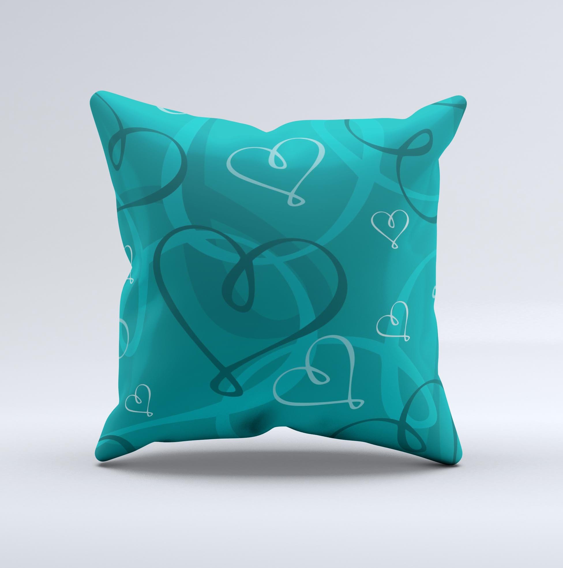 Teal decorative throw pillow featuring swirly love hearts design, handcrafted in Virginia with high thread count fabric.