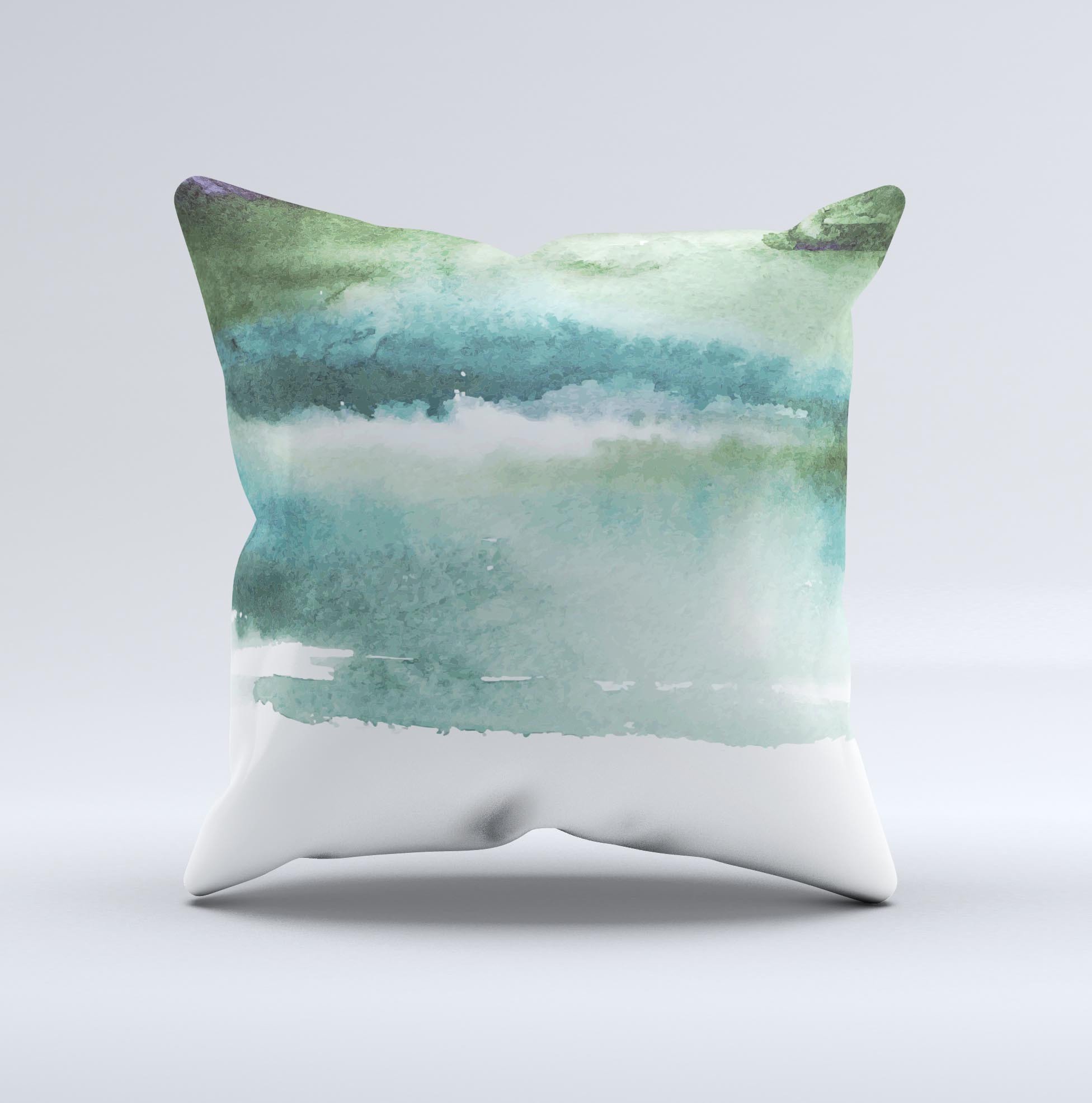 A decorative throw pillow featuring greenish watercolor strokes, handcrafted in Virginia, showcasing unique artistic design.