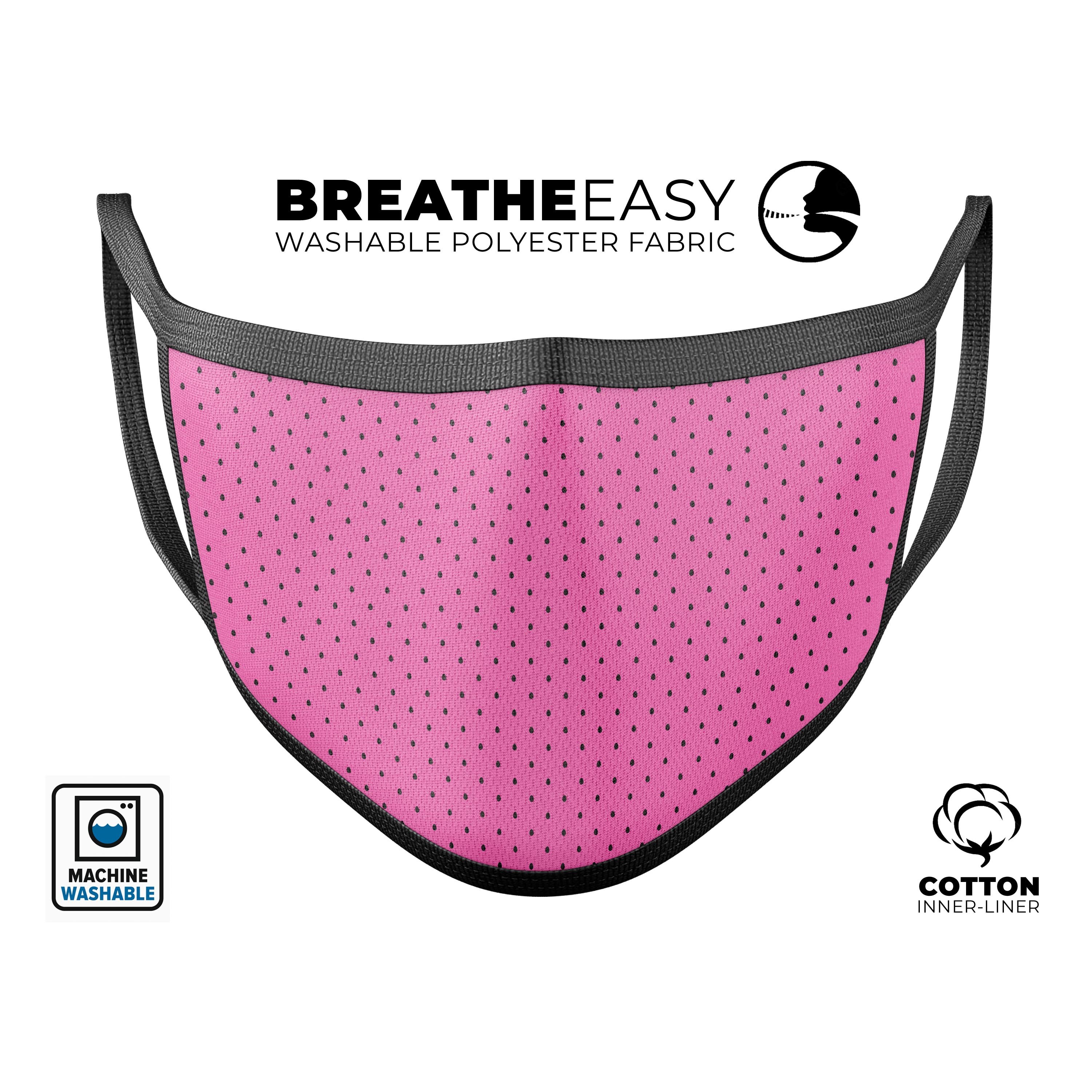 A stylish pink and black micro polka dot pattern mouth cover, showcasing its vibrant colors and adjustable ear loops.
