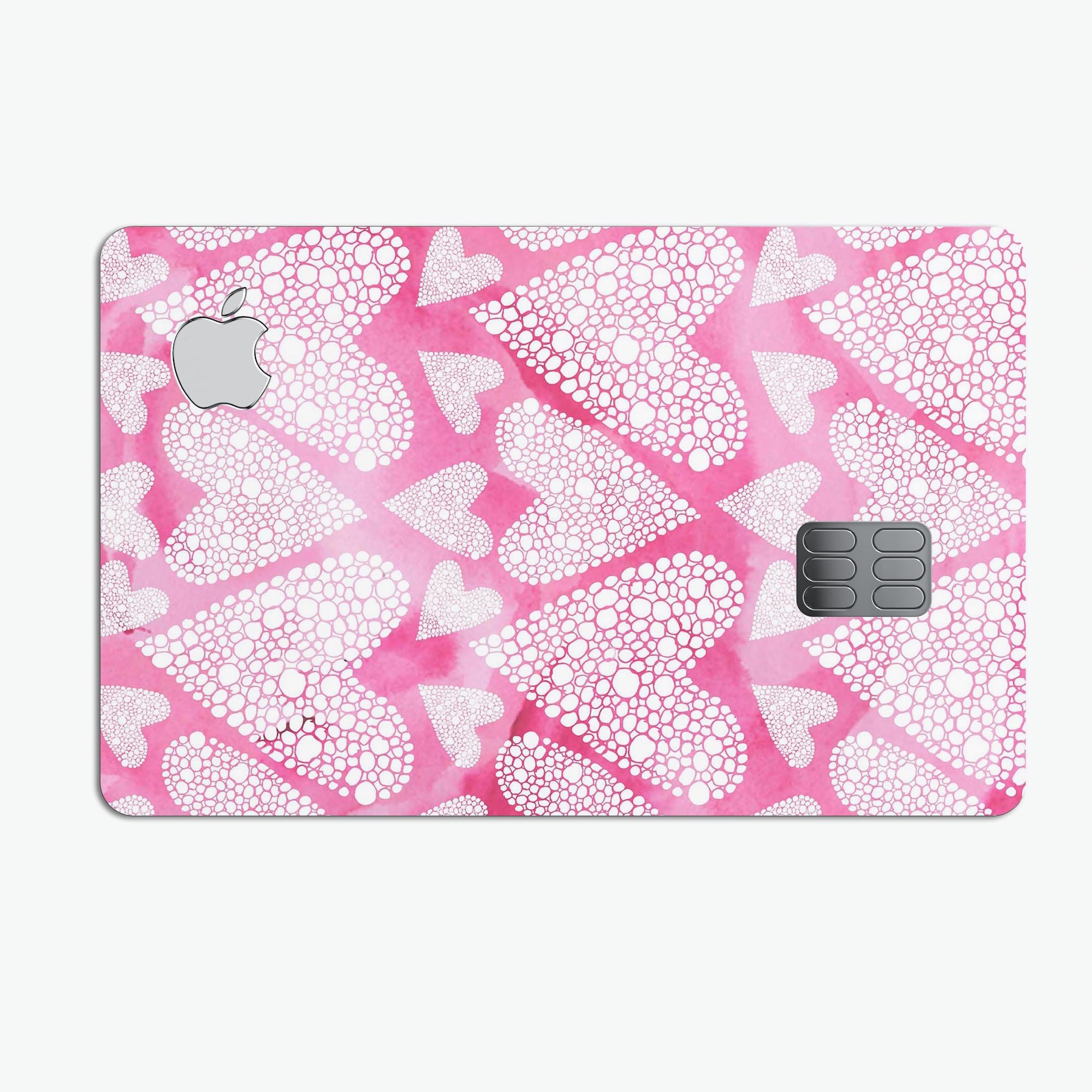 The Pink Watercolor Mosaic Hearts decal skin for Apple Card, showcasing vibrant heart patterns on a protective vinyl layer.