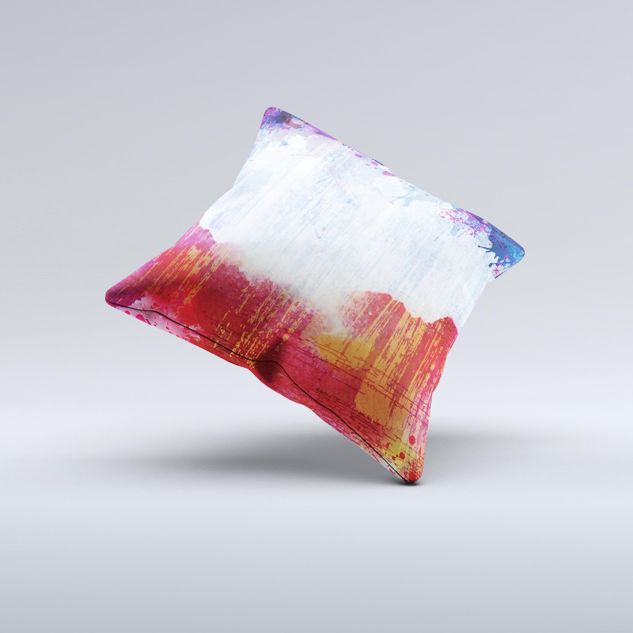 A decorative throw pillow featuring vibrant red, white, and blue paint splotches, handcrafted in Virginia, showcasing unique design elements.