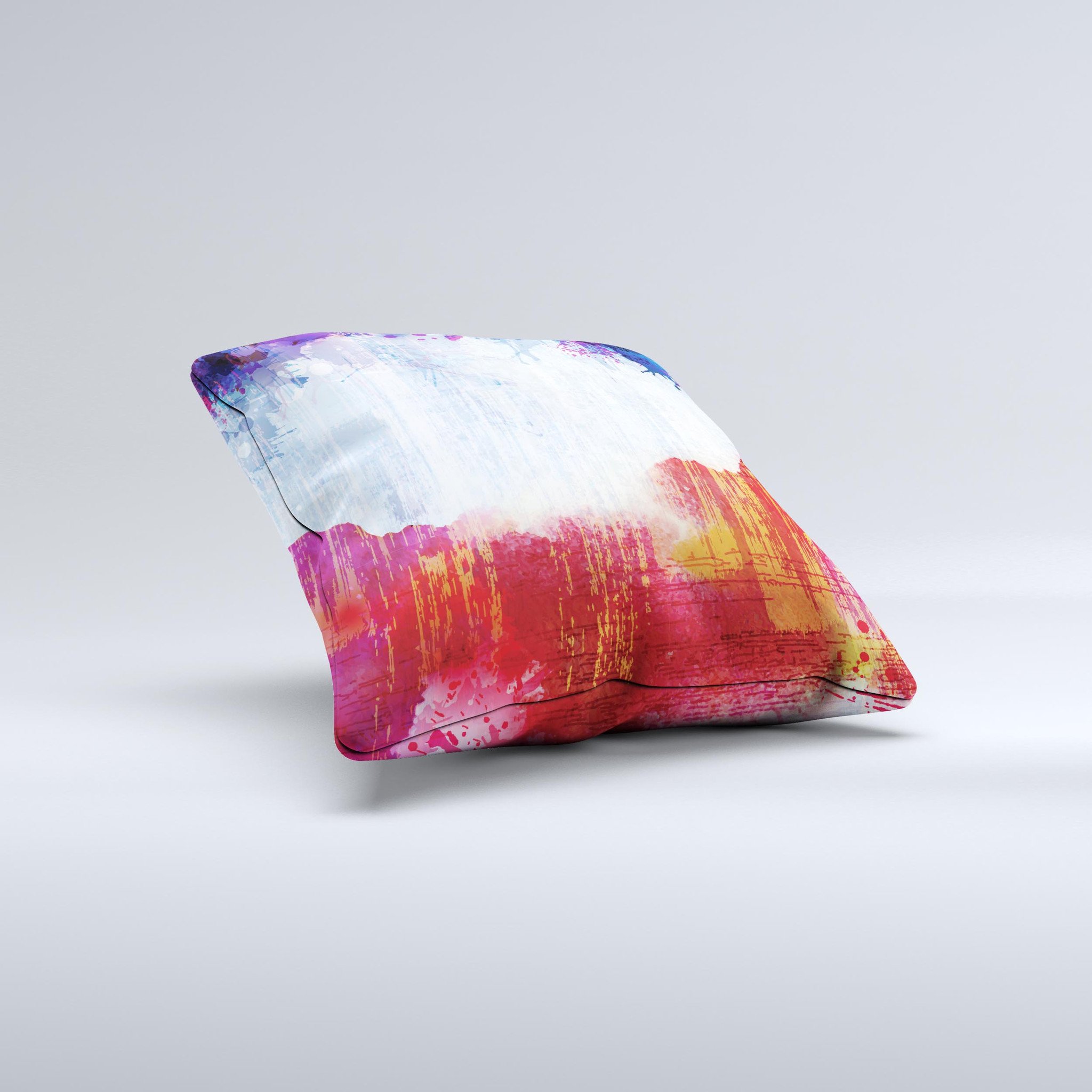 A decorative throw pillow featuring vibrant red, white, and blue paint splotches, handcrafted in Virginia, showcasing unique design elements.