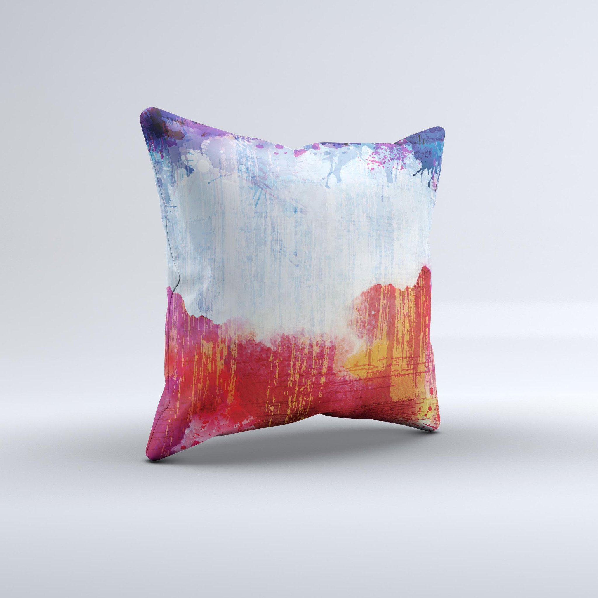 A decorative throw pillow featuring vibrant red, white, and blue paint splotches, handcrafted in Virginia, showcasing unique design elements.