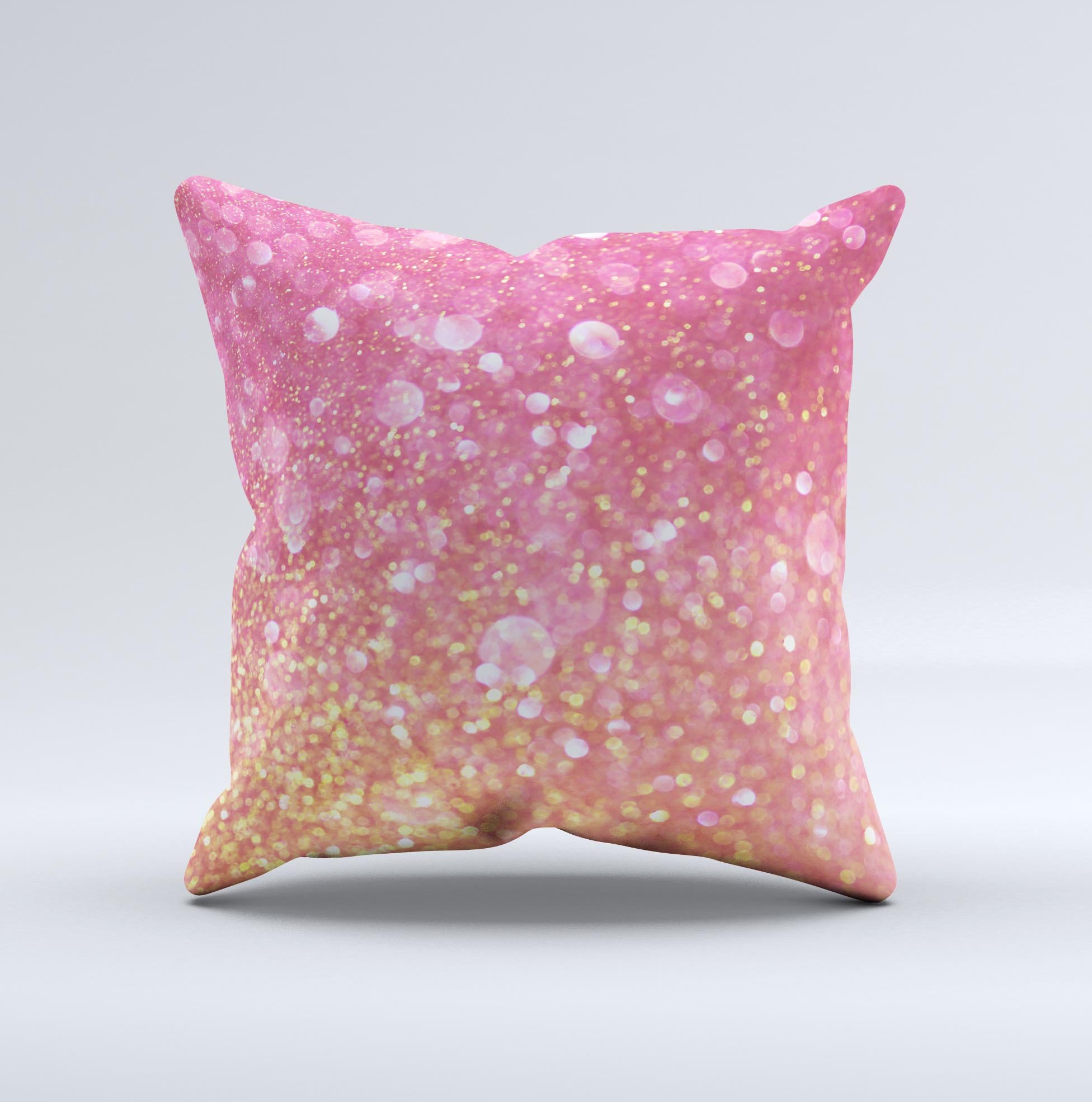 A decorative throw pillow featuring unfocused pink and gold orbs, showcasing a unique handmade design with a luxurious fabric finish.