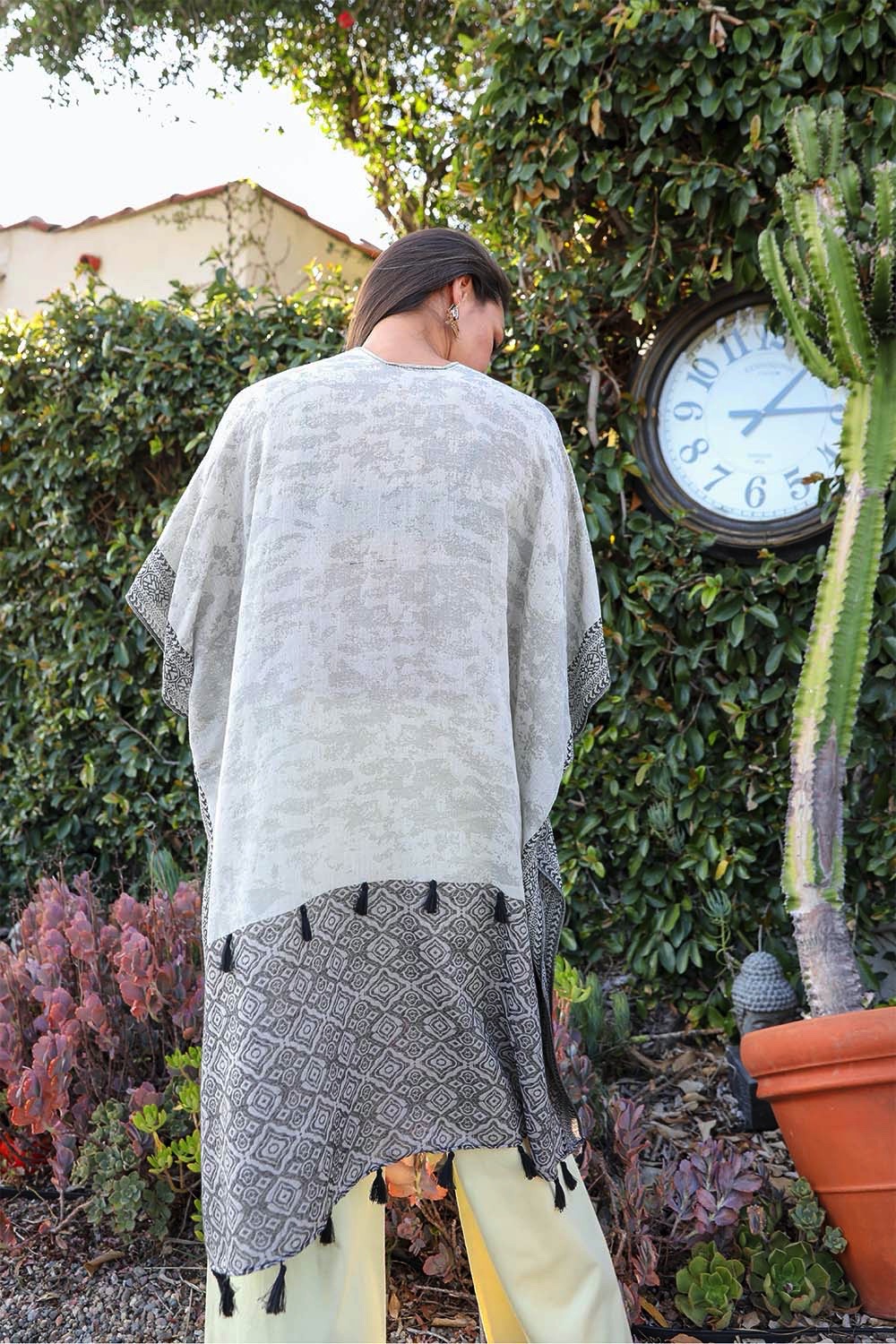 Tropical Leaves Draped Sleeve Kimono featuring a chic two-tone design and playful tassels, perfect for stylish layering.