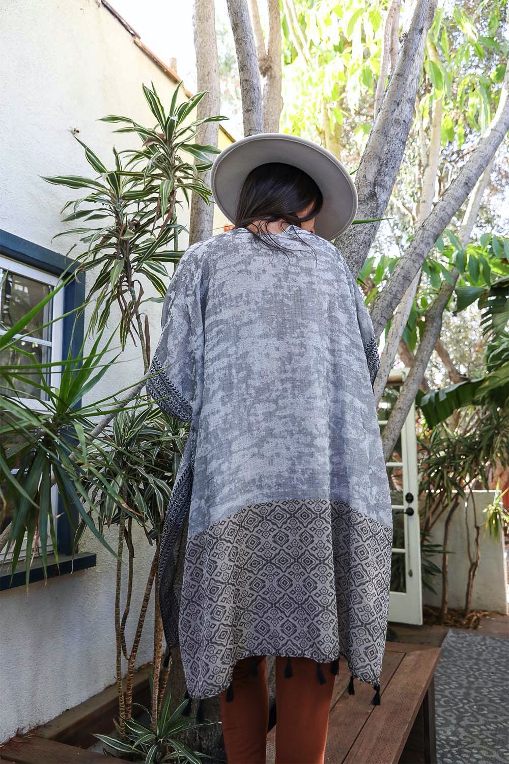 Tropical Leaves Draped Sleeve Kimono featuring a chic two-tone design and playful tassels, perfect for stylish layering.