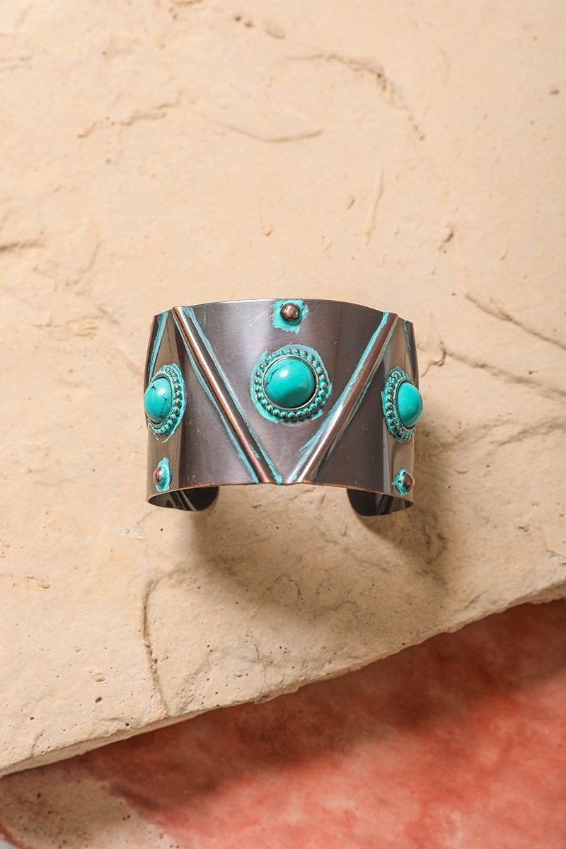 Turquoise Stone Studded Cuff featuring bronze studs on a sturdy metal base, showcasing a rustic boho style.