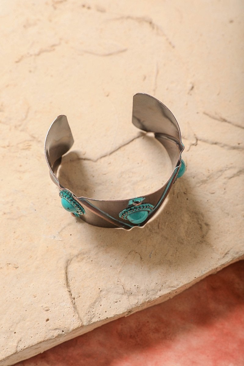 Turquoise Stone Studded Cuff featuring bronze studs on a sturdy metal base, showcasing a rustic boho style.