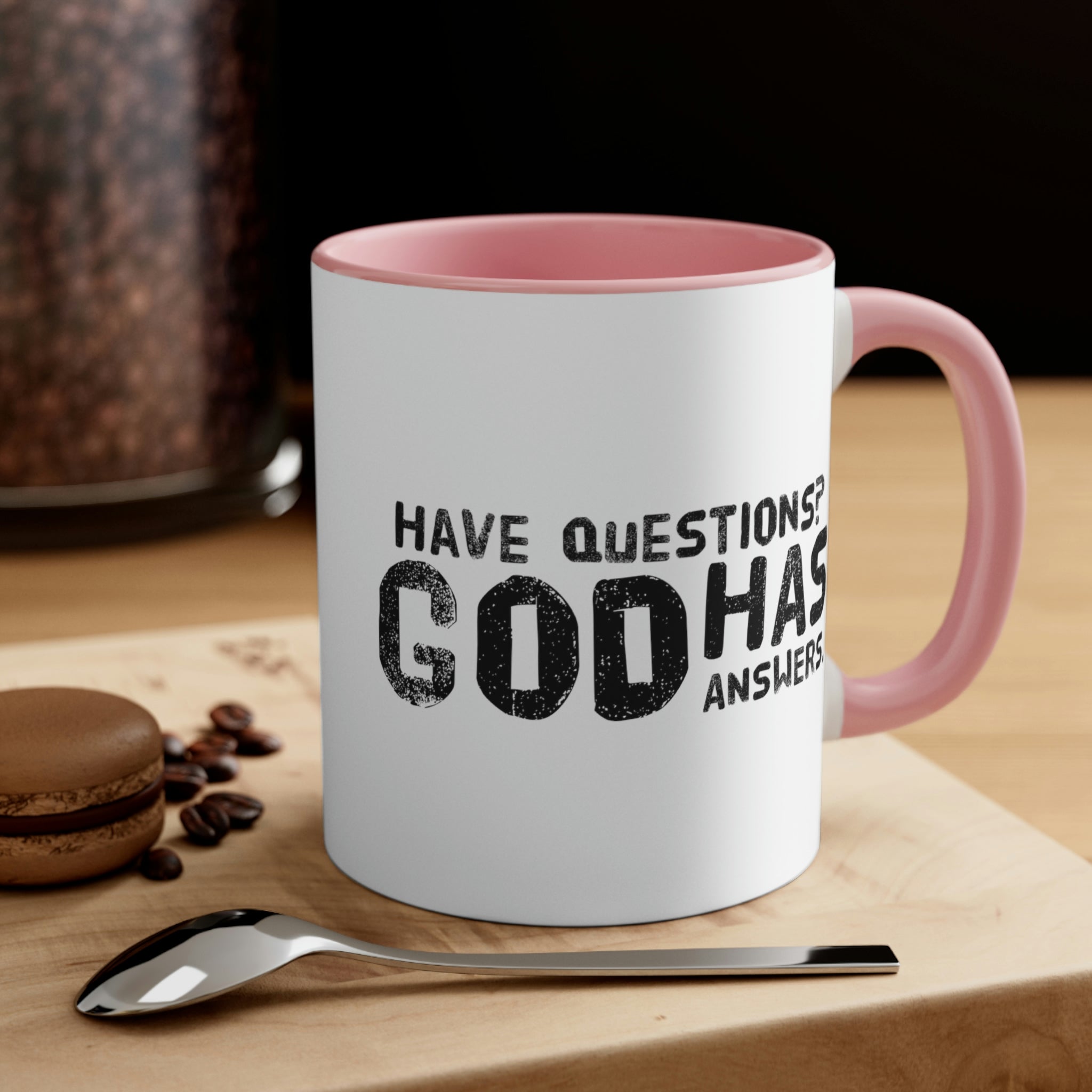 Two-tone ceramic mug with a colorful interior and handle, featuring the print 'Have Questions? God has Answers'.