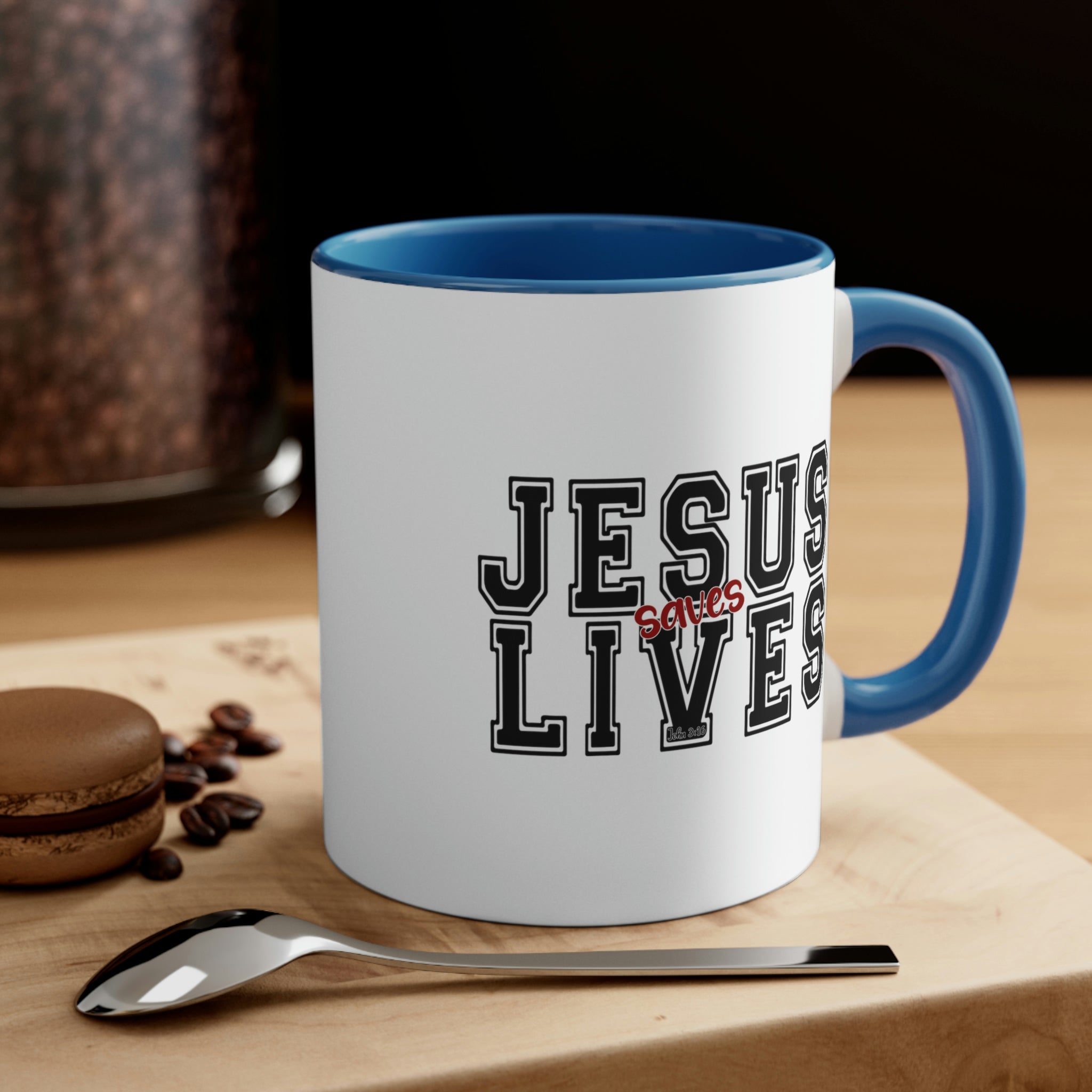 Two-tone ceramic mug with a C-handle, featuring a colored interior and the text 'Jesus Saves Lives' in a vibrant design.
