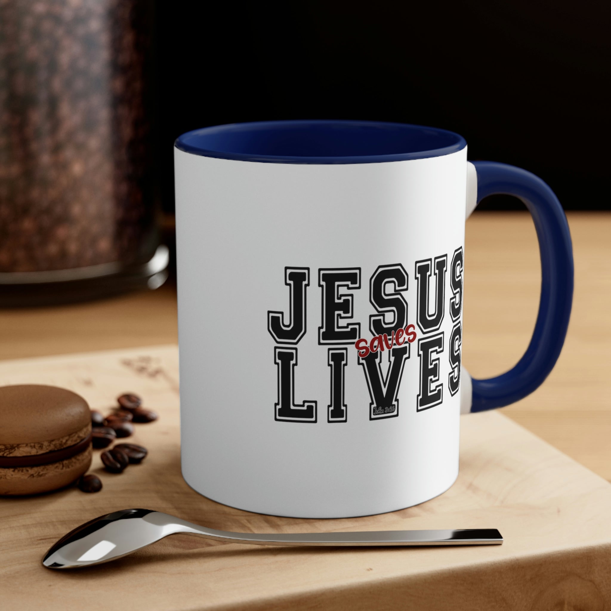 Two-tone ceramic mug with a C-handle, featuring a colored interior and the text 'Jesus Saves Lives' in a vibrant design.