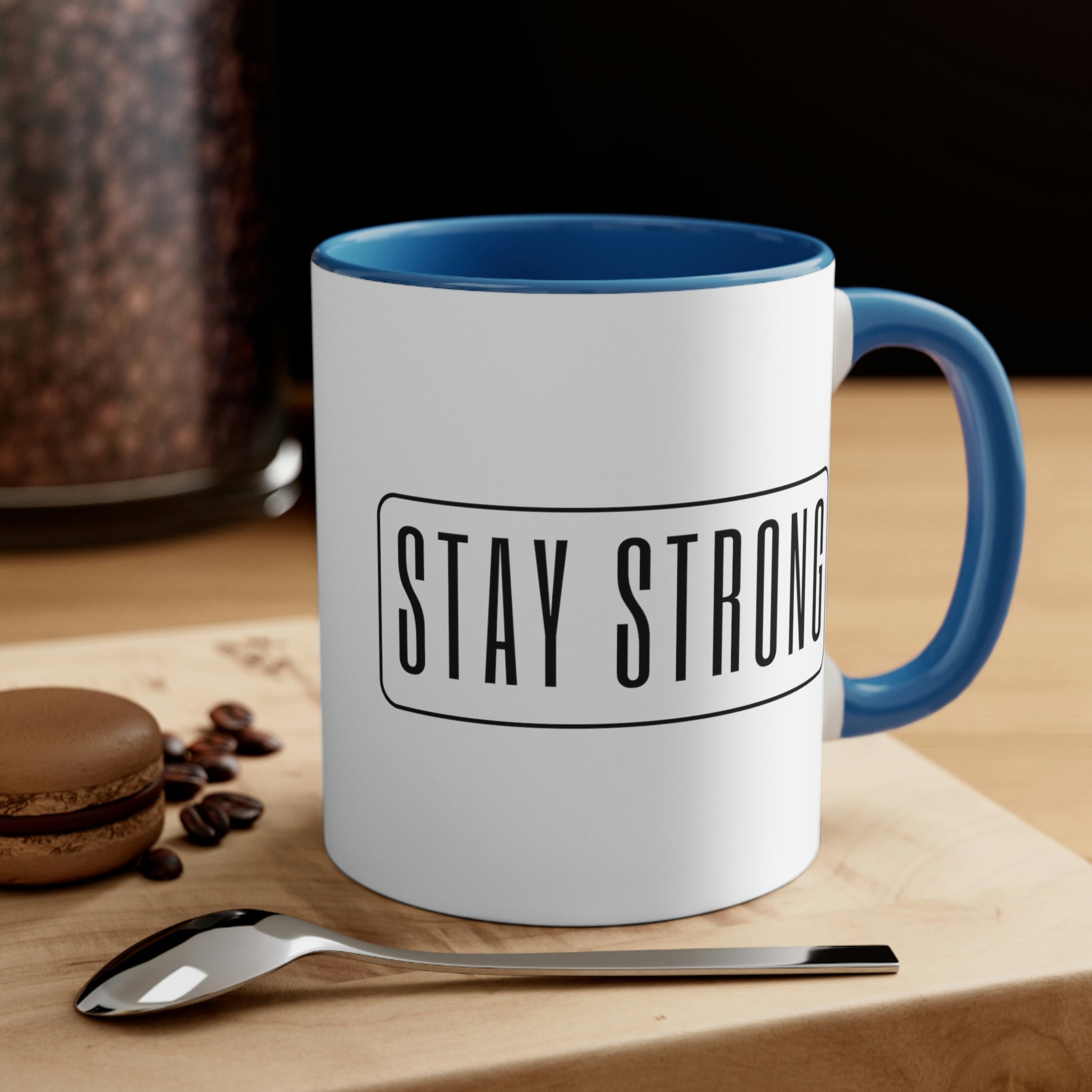 Two-tone ceramic mug with a white exterior and colored interior featuring a Stay Strong illustration, showcasing a comfortable C-handle.