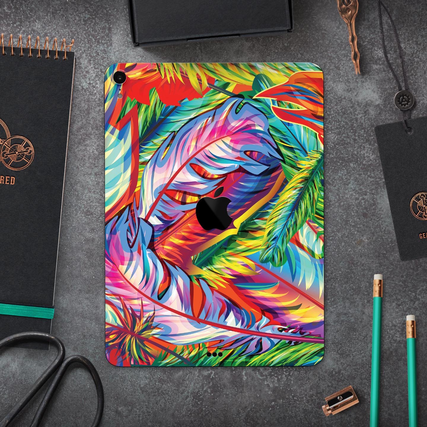 Vibrant colorful feathers skin decal for Apple iPad, showcasing intricate feather designs and premium finish.