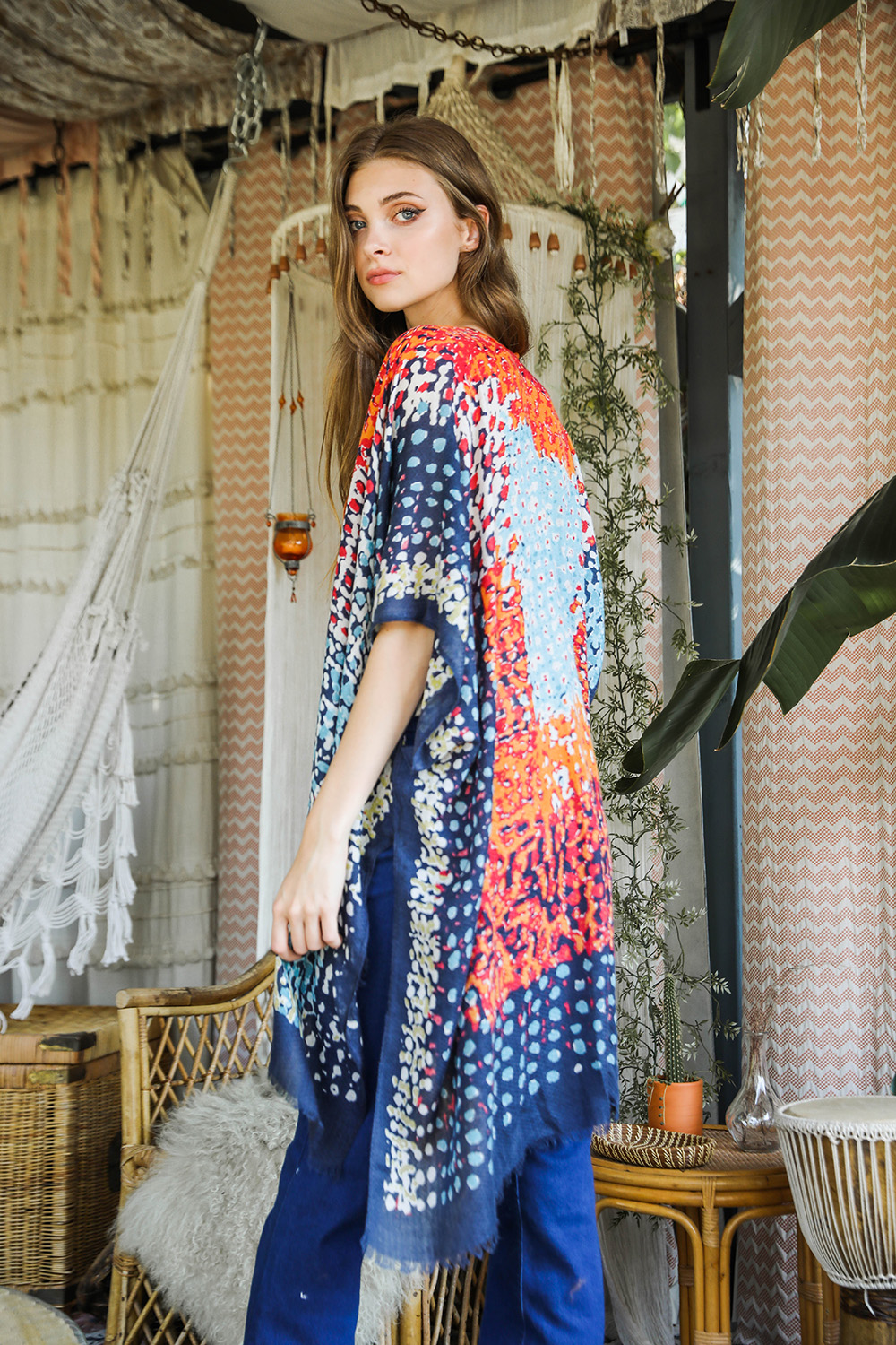 A vibrant multicolor frayed kimono showcasing a retro design, perfect for stylish layering.