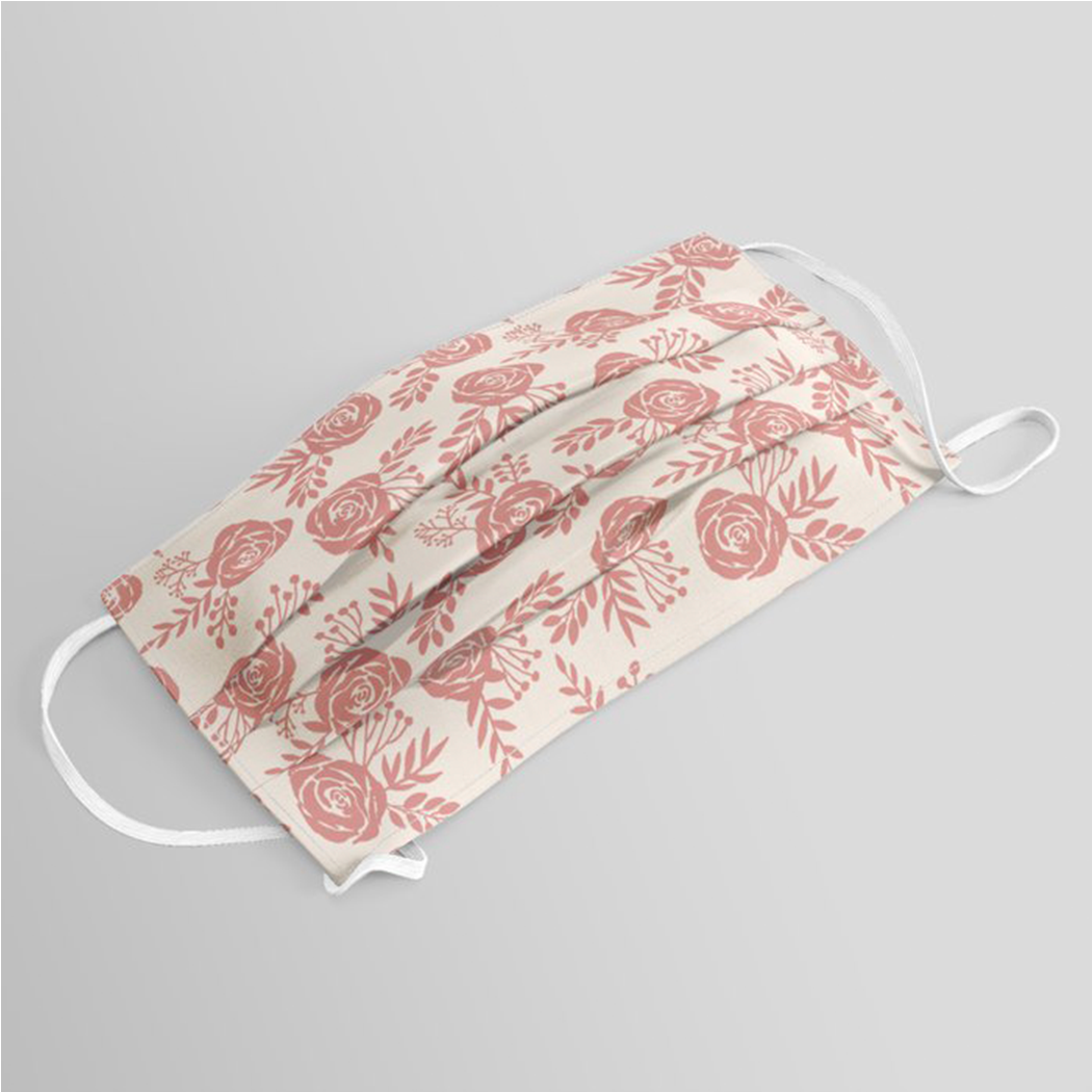 Warm pink floral face mask with pleated design and elastic ear loops, perfect for stylish protection.