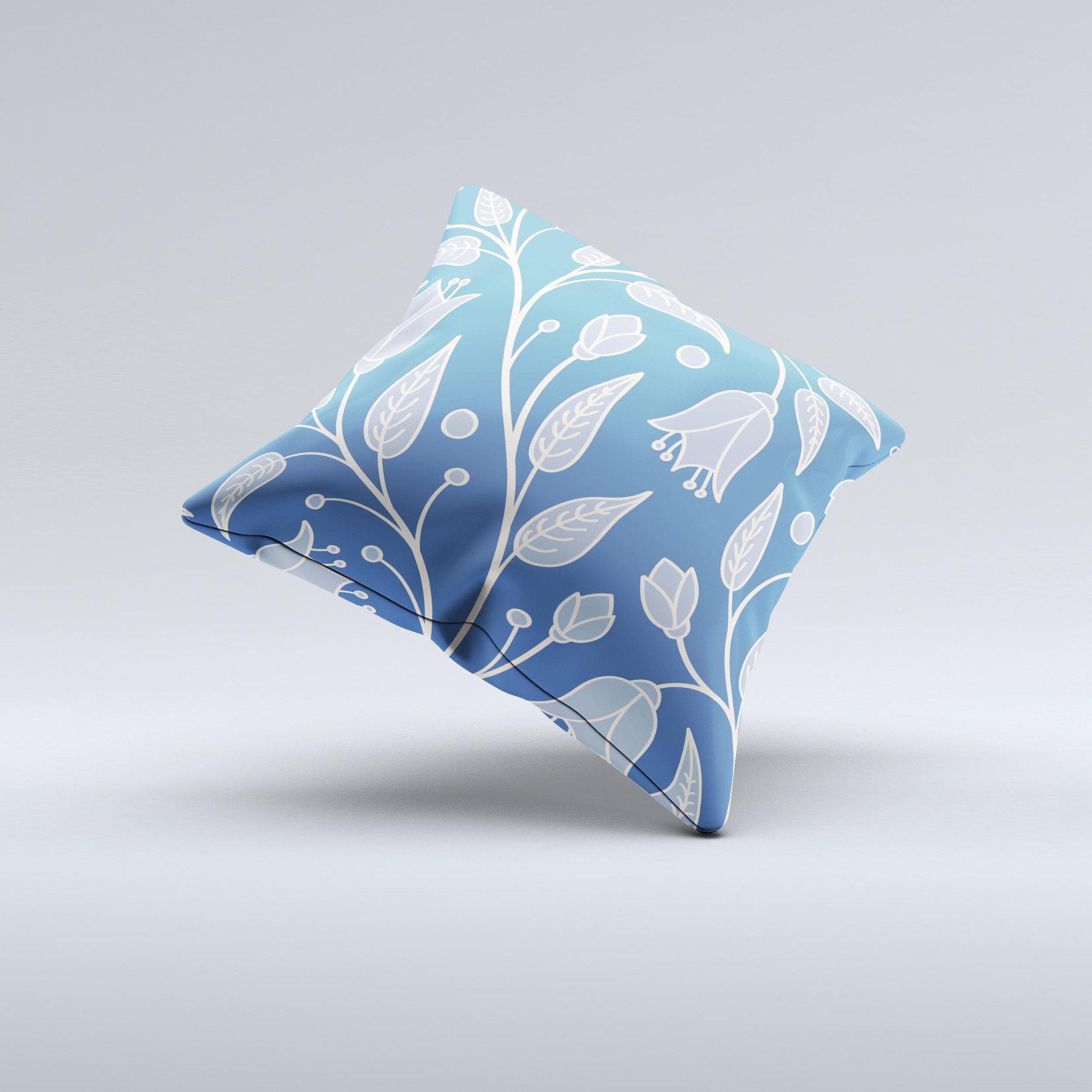 White and blue decorative throw pillow featuring vector branches design, handcrafted in Virginia.